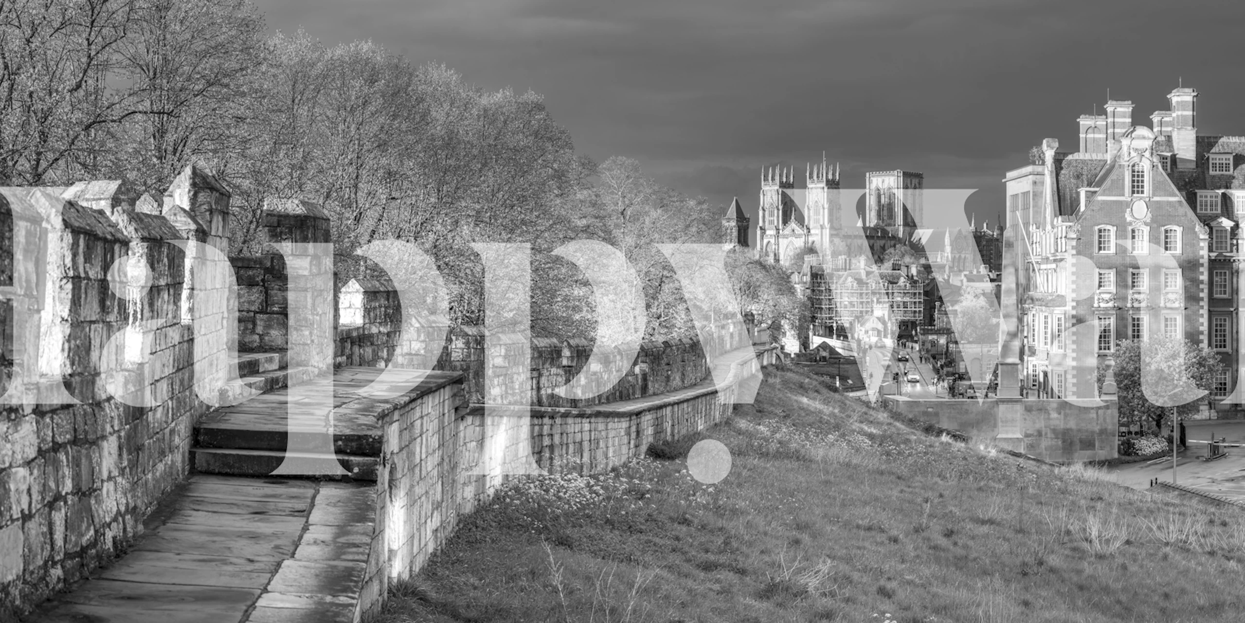 Black and white medieval cityscape wallpaper featuring historical buildings and trees