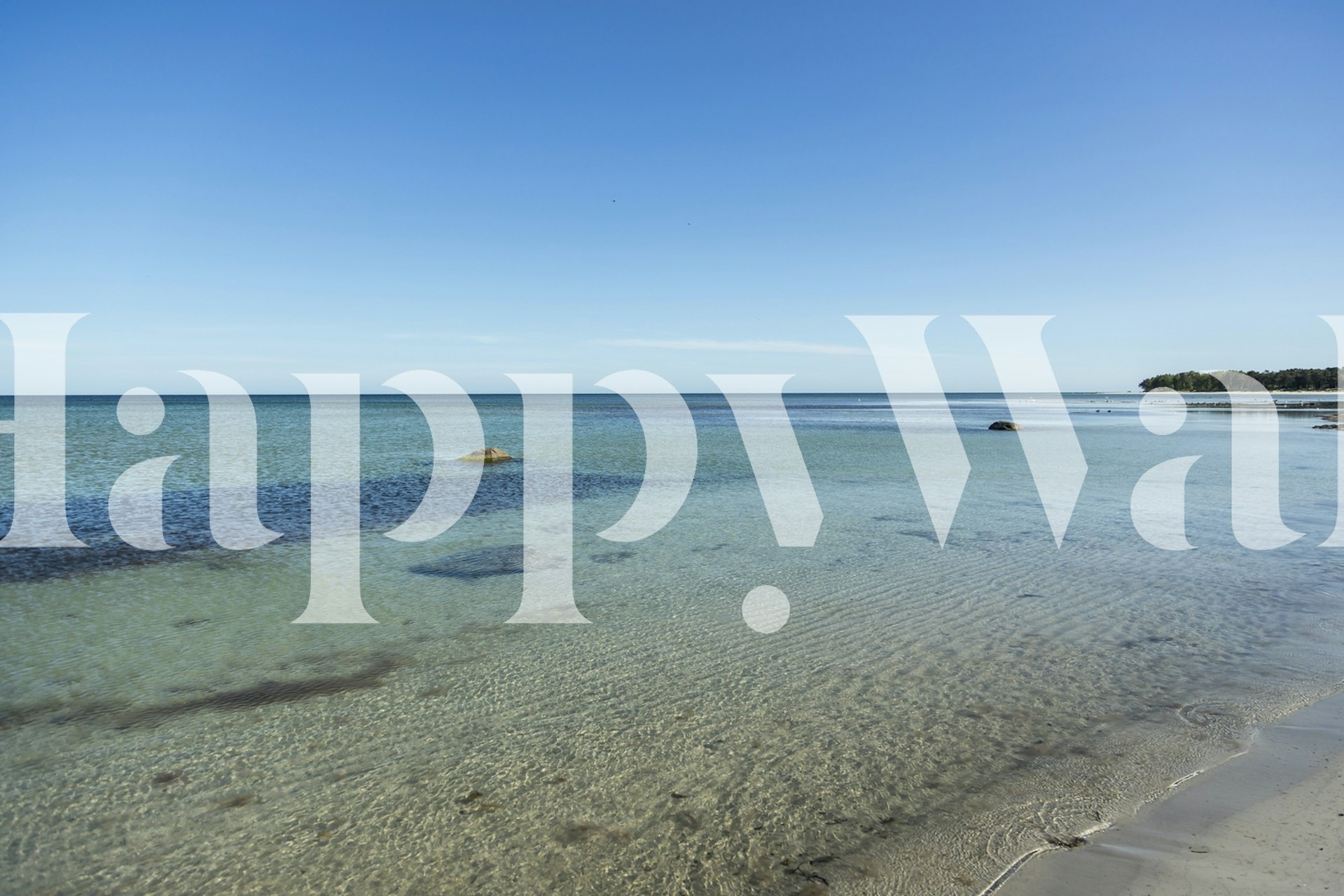 Tranquil beach scene with blue water and clear sky wallpaper