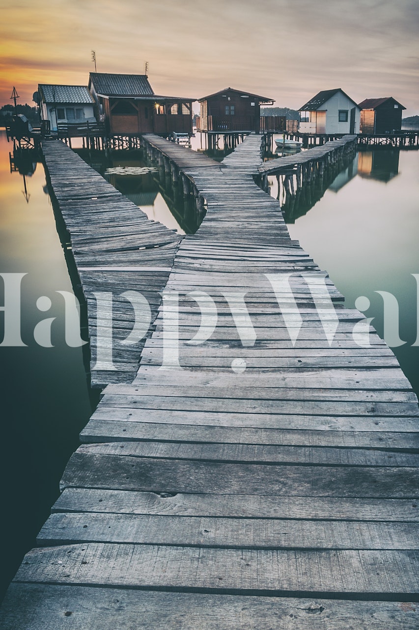 Wooden walkway leading to lakeside cottages at sunset wallpaper