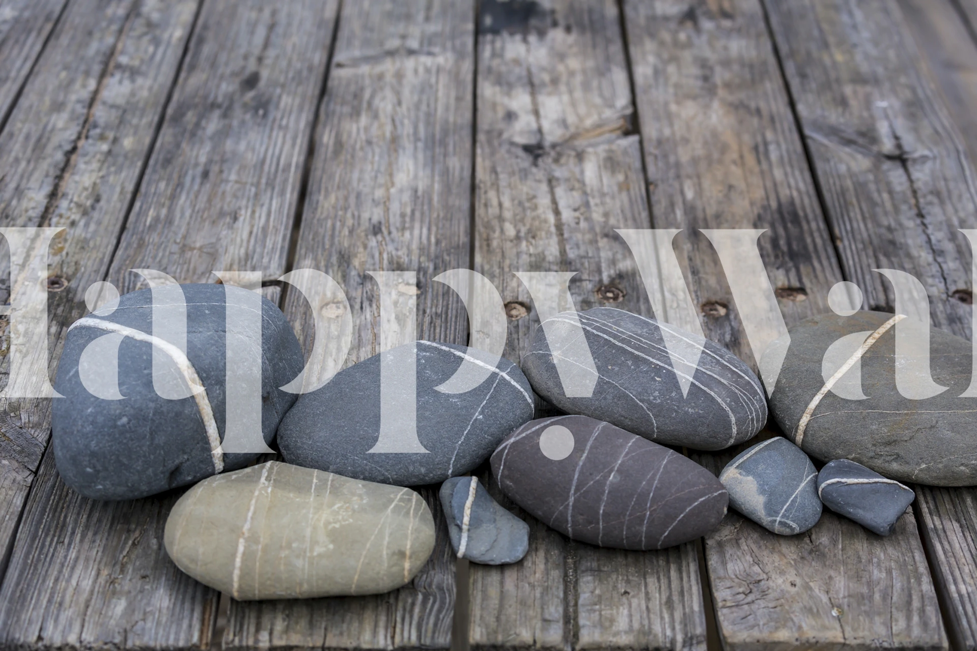 Various pebbles on textured wood background wallpaper