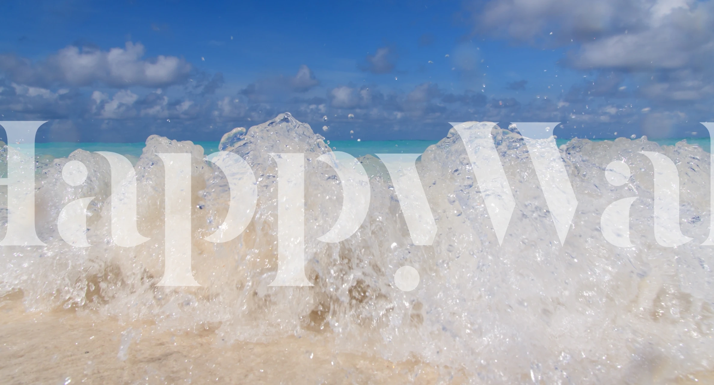 Ocean waves crashing on sandy beach with blue sky wallpaper