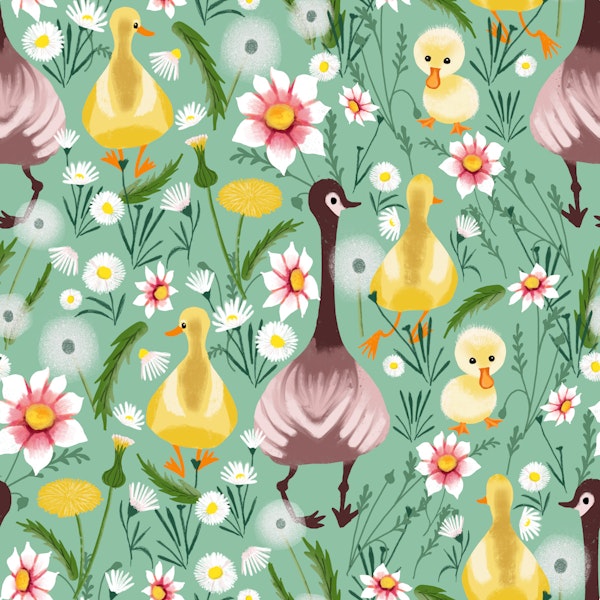 Goose and ducklings on spring meadow