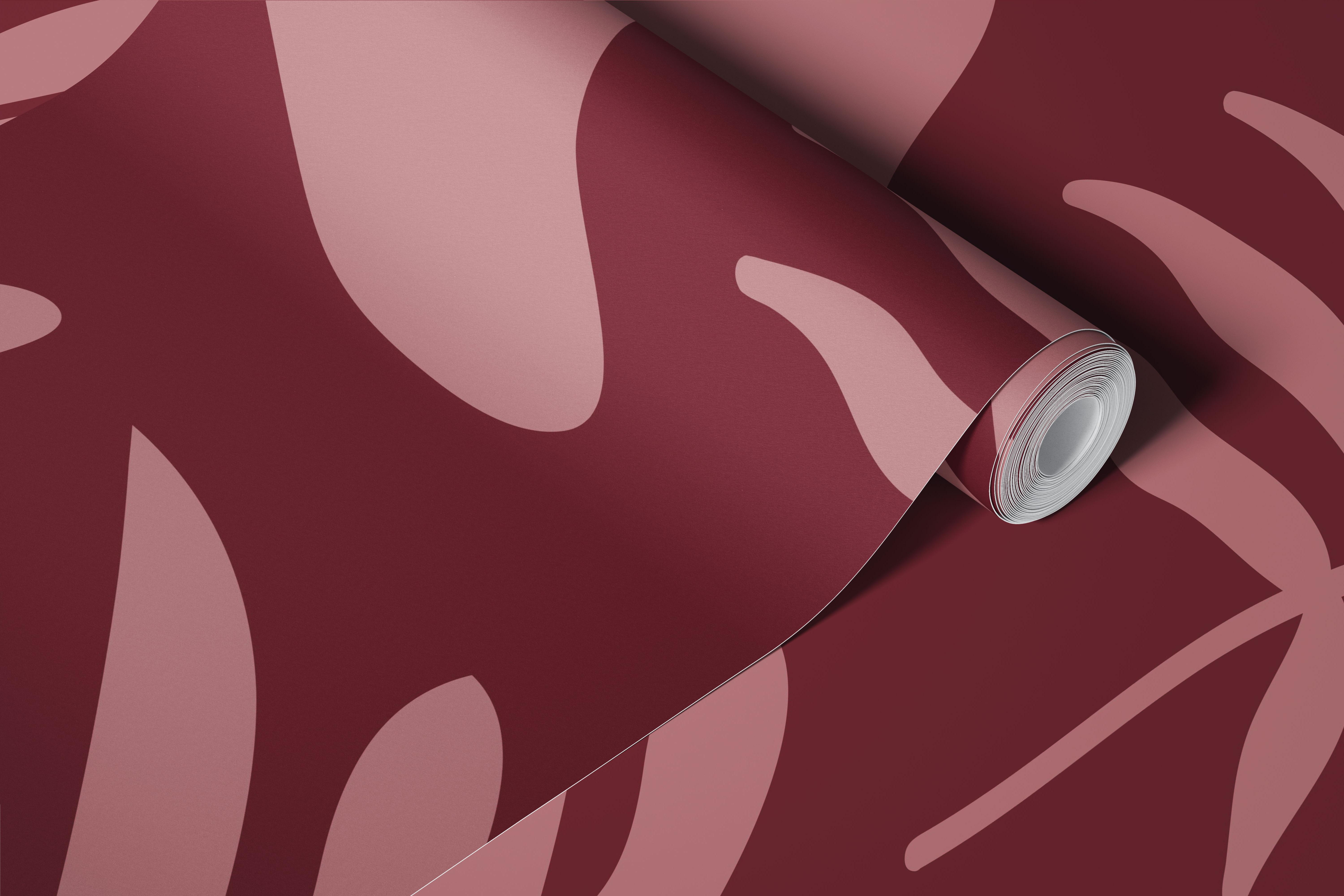 Abstract botanical motifs in muted pink on deep red wallpaper