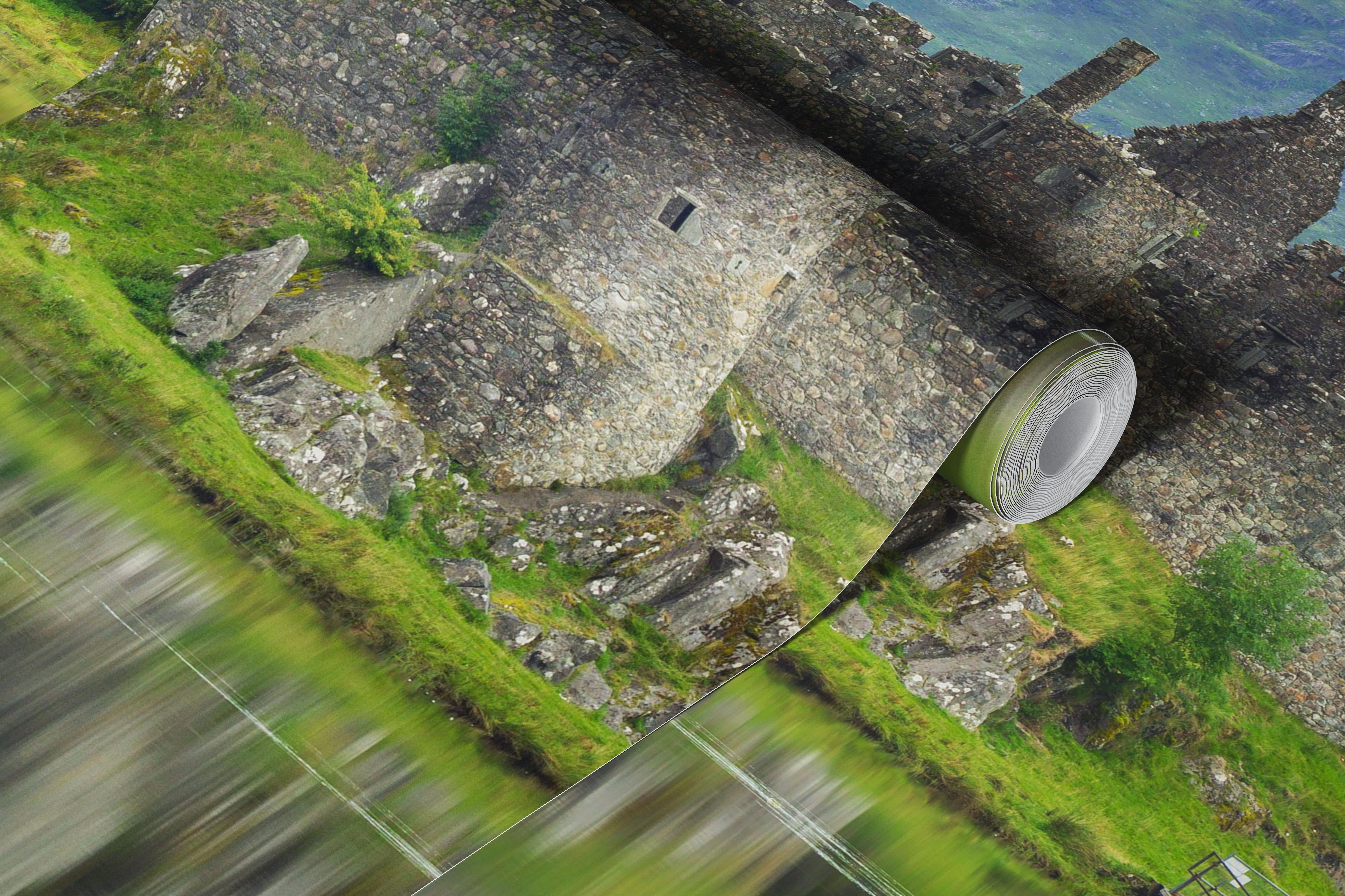 Kilchurn Castle reflecting in tranquil water surrounded by green hills wallpaper