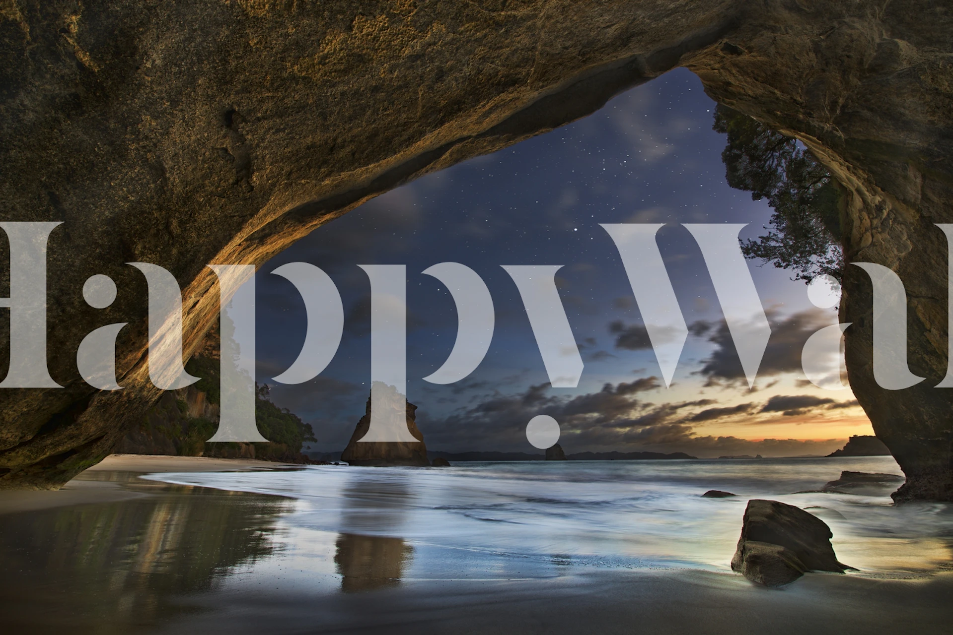 Stunning ocean view through rock arch at sunset wallpaper