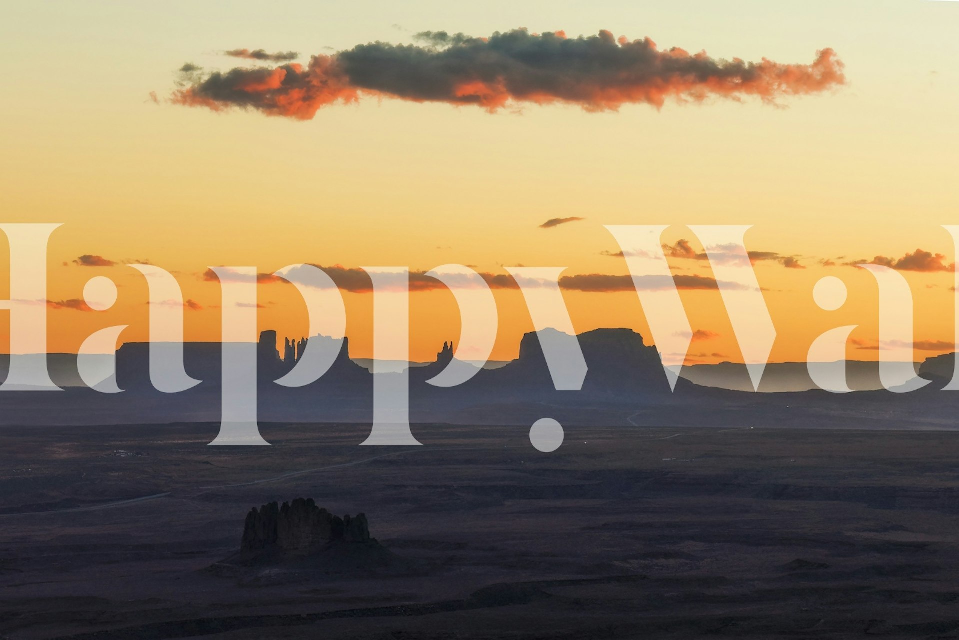 Silhouetted desert landscape at twilight with warm colors wallpaper