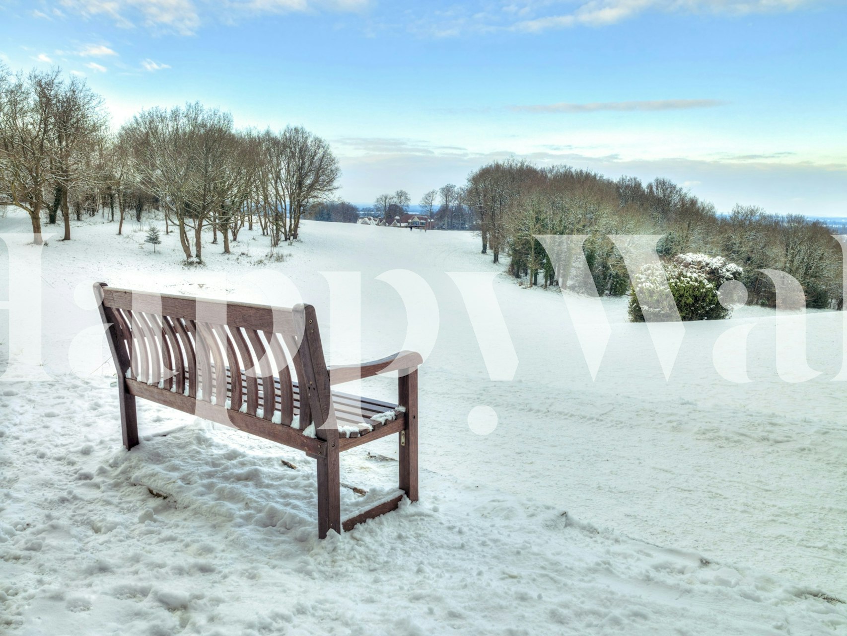 Bench in snowy landscape wallpaper