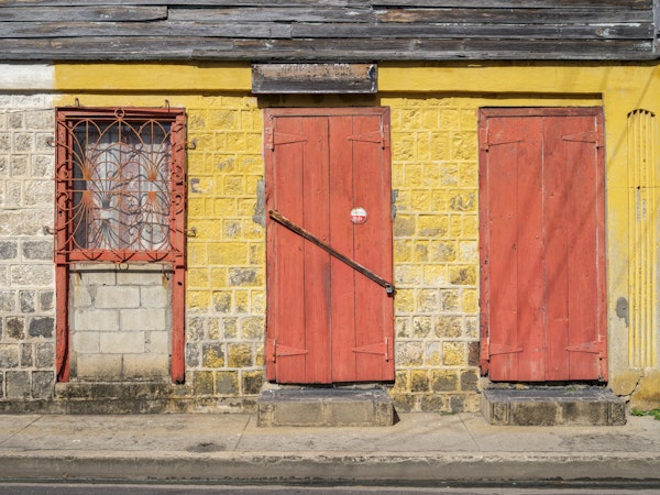 Weathered Brick Wall and Red Doors