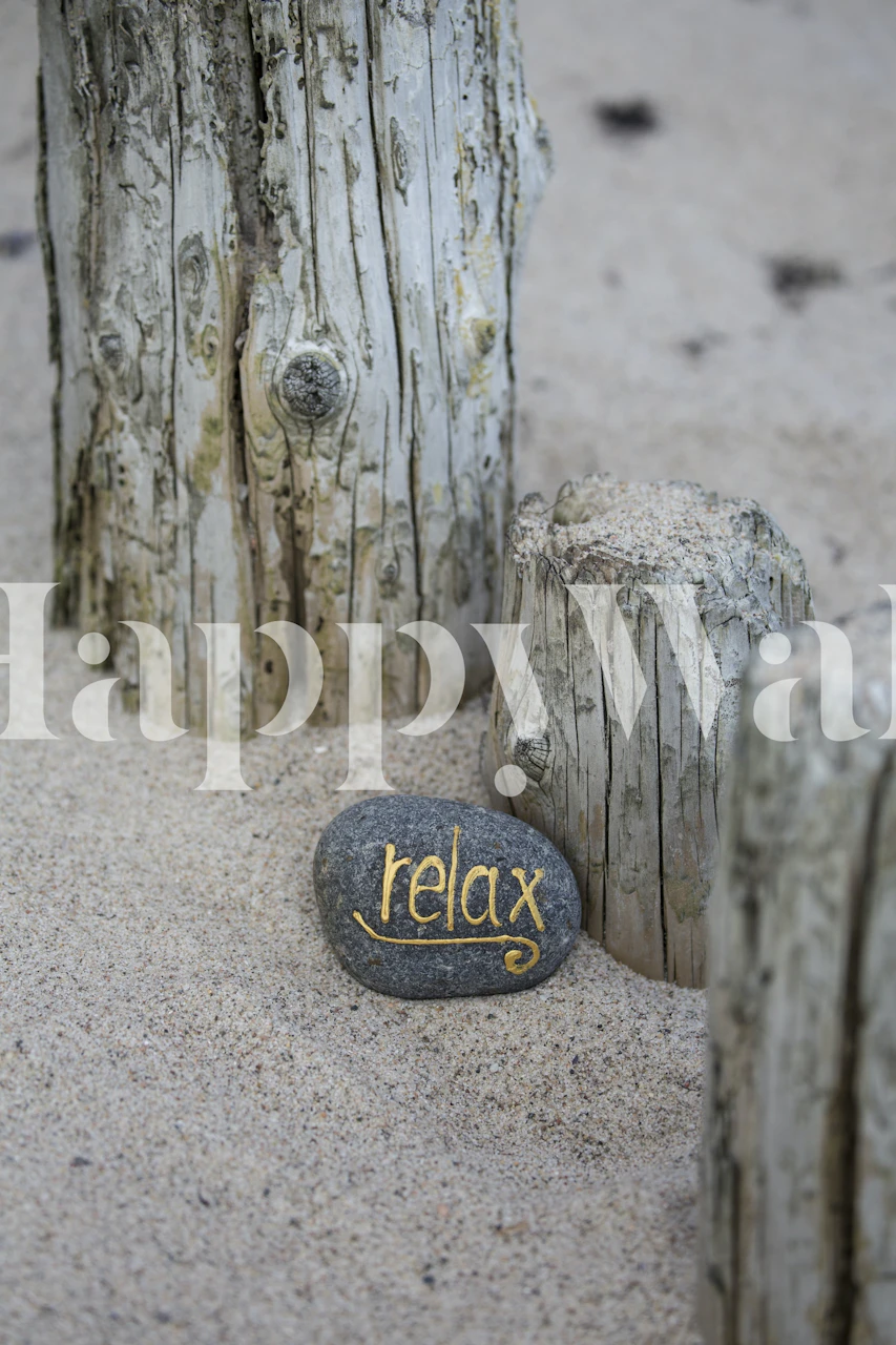 Relax lettering on grey pebble surrounded by wooden posts wallpaper