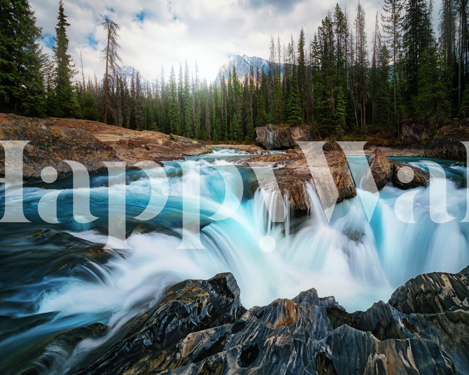 Blue waterfall over rocks in a forest setting wallpaper