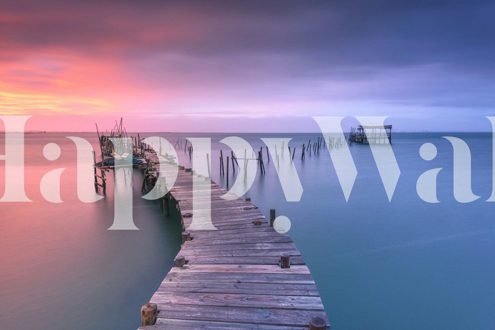 Wooden pier against a sunset sky with calm waters wallpaper
