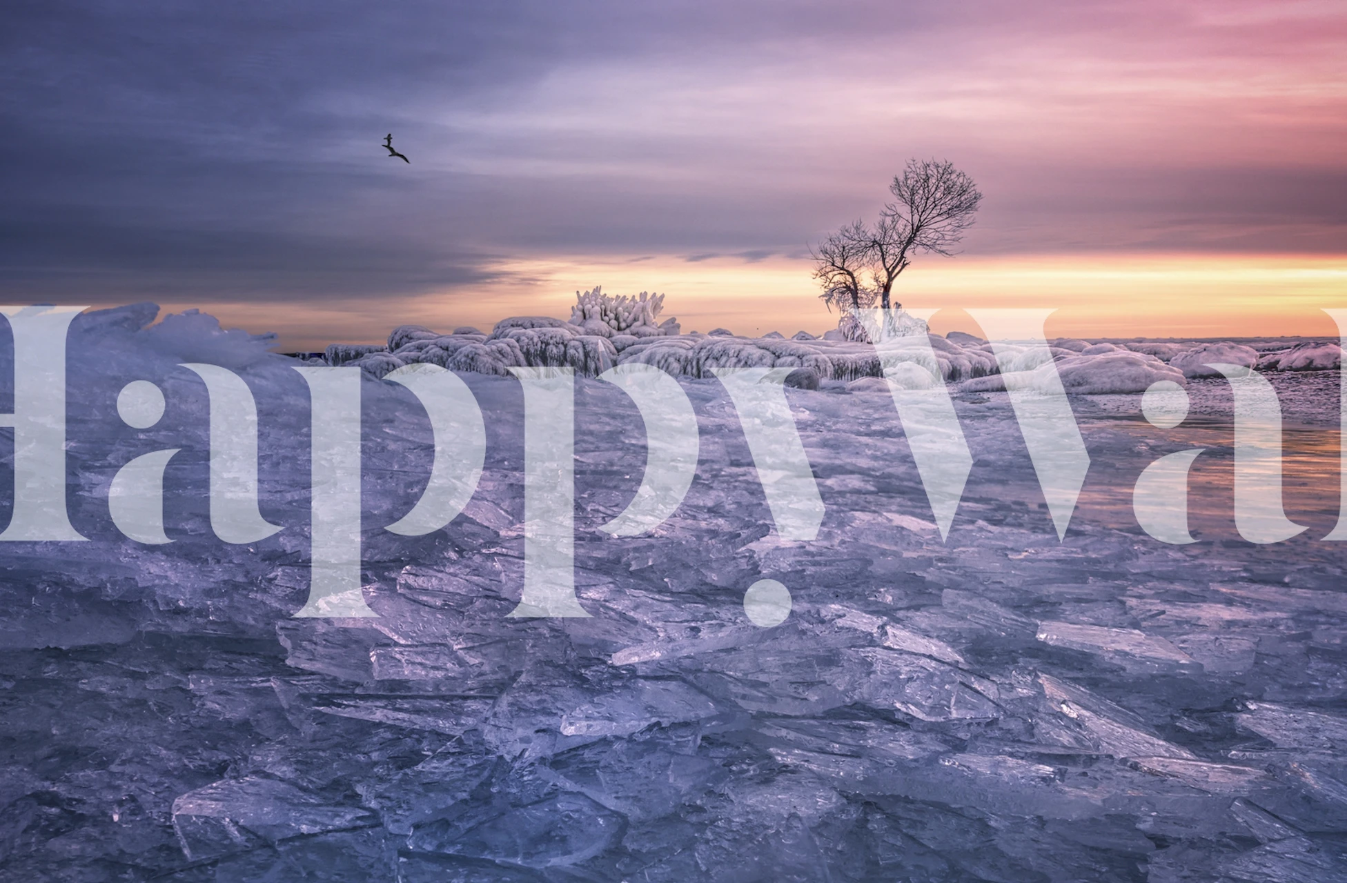 A serene winter scene wall mural with a solitary tree and twilight hues over a frosted landscape.