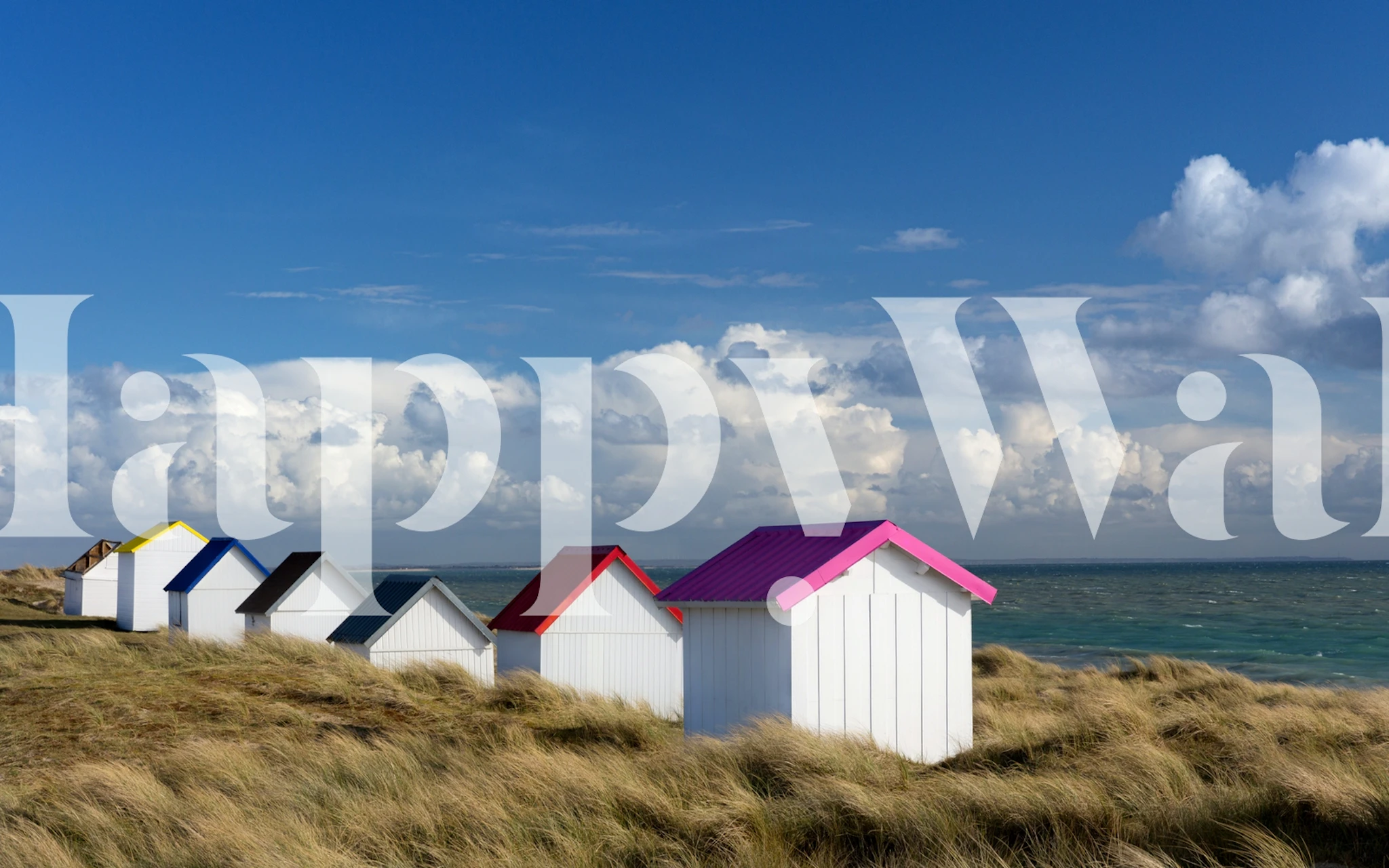 Beach huts in various colors against a blue sky wallpaper