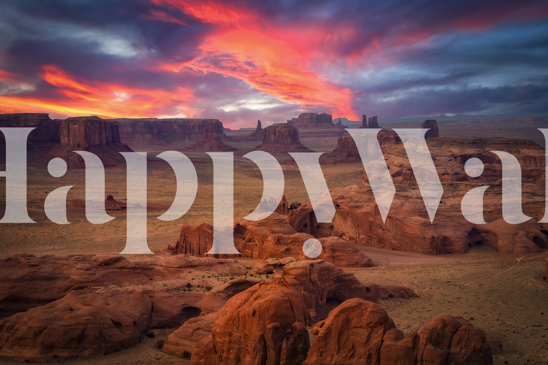 Desert sunset landscape wallpaper featuring red rocks and colorful skies