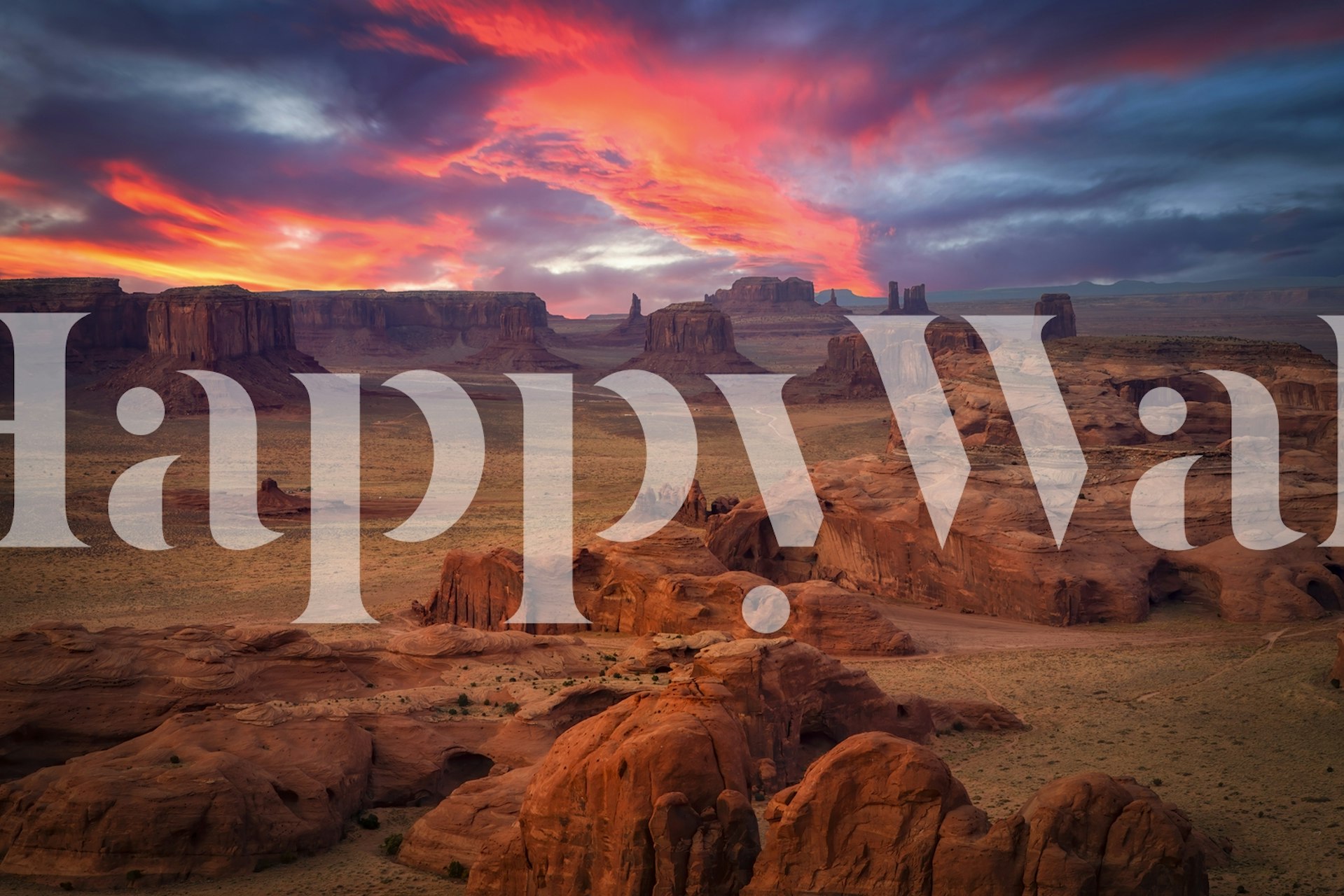 Desert sunset landscape wallpaper featuring red rocks and colorful skies