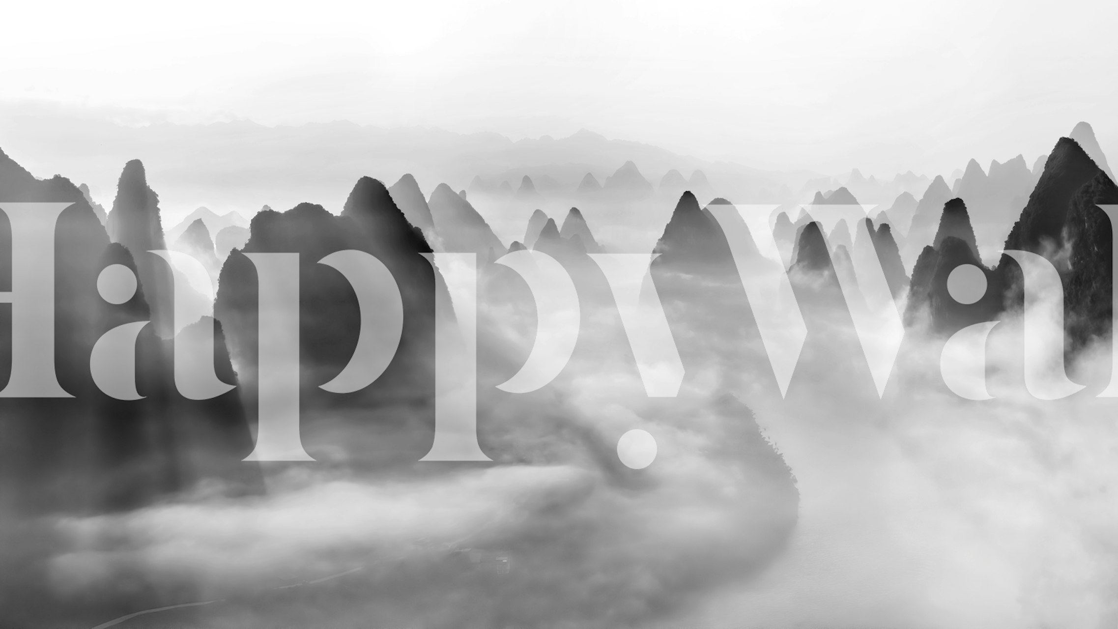 Black and white mountain fog wallpaper featuring misty peaks