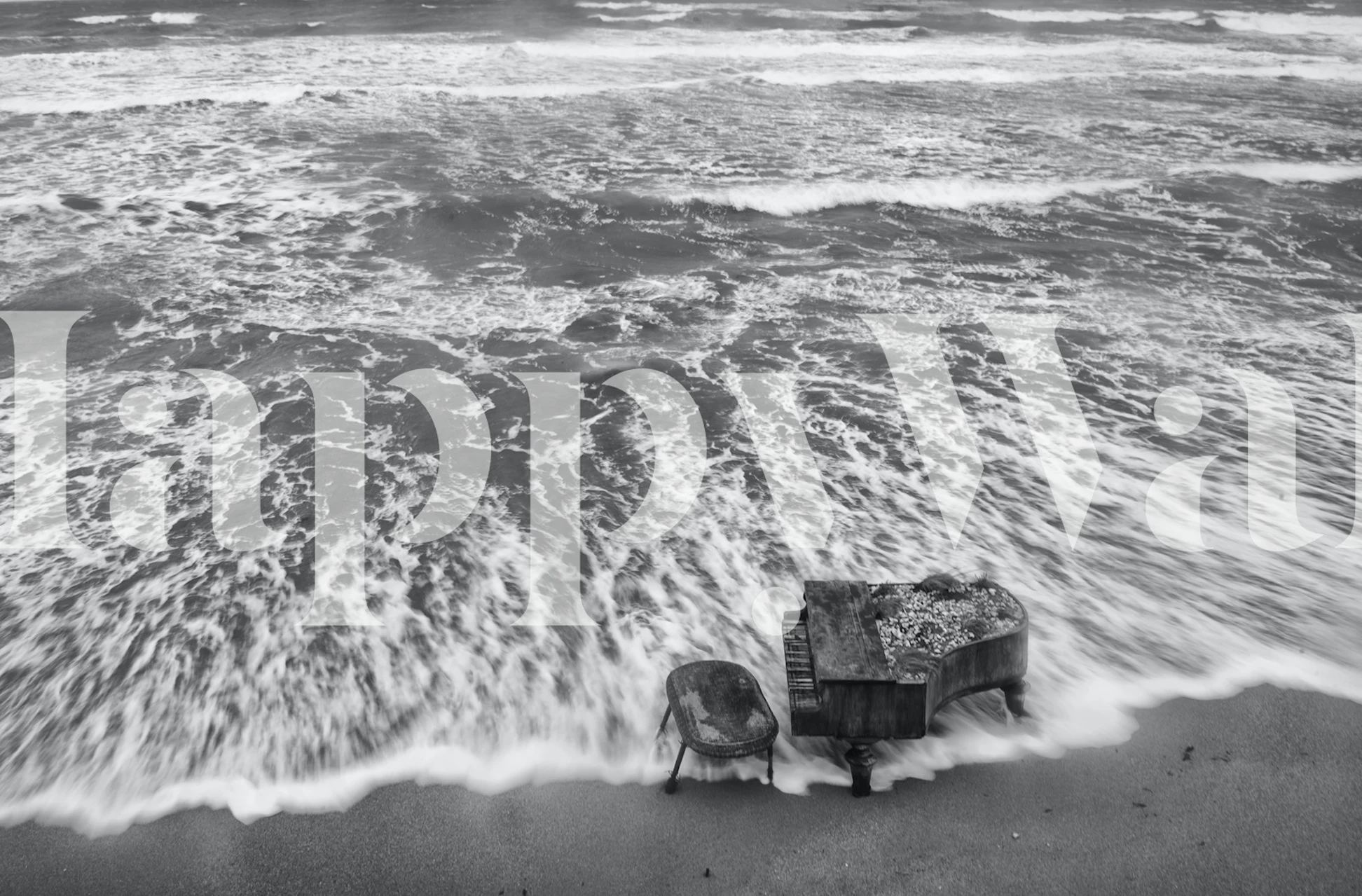 Piano by the ocean with waves crashing, black and white wallpaper