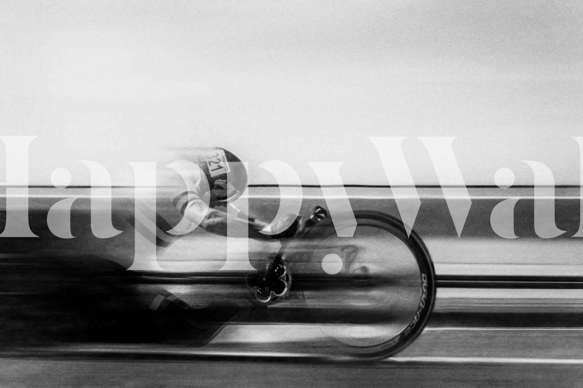 A cyclist in motion, captured in black and white wallpaper.
