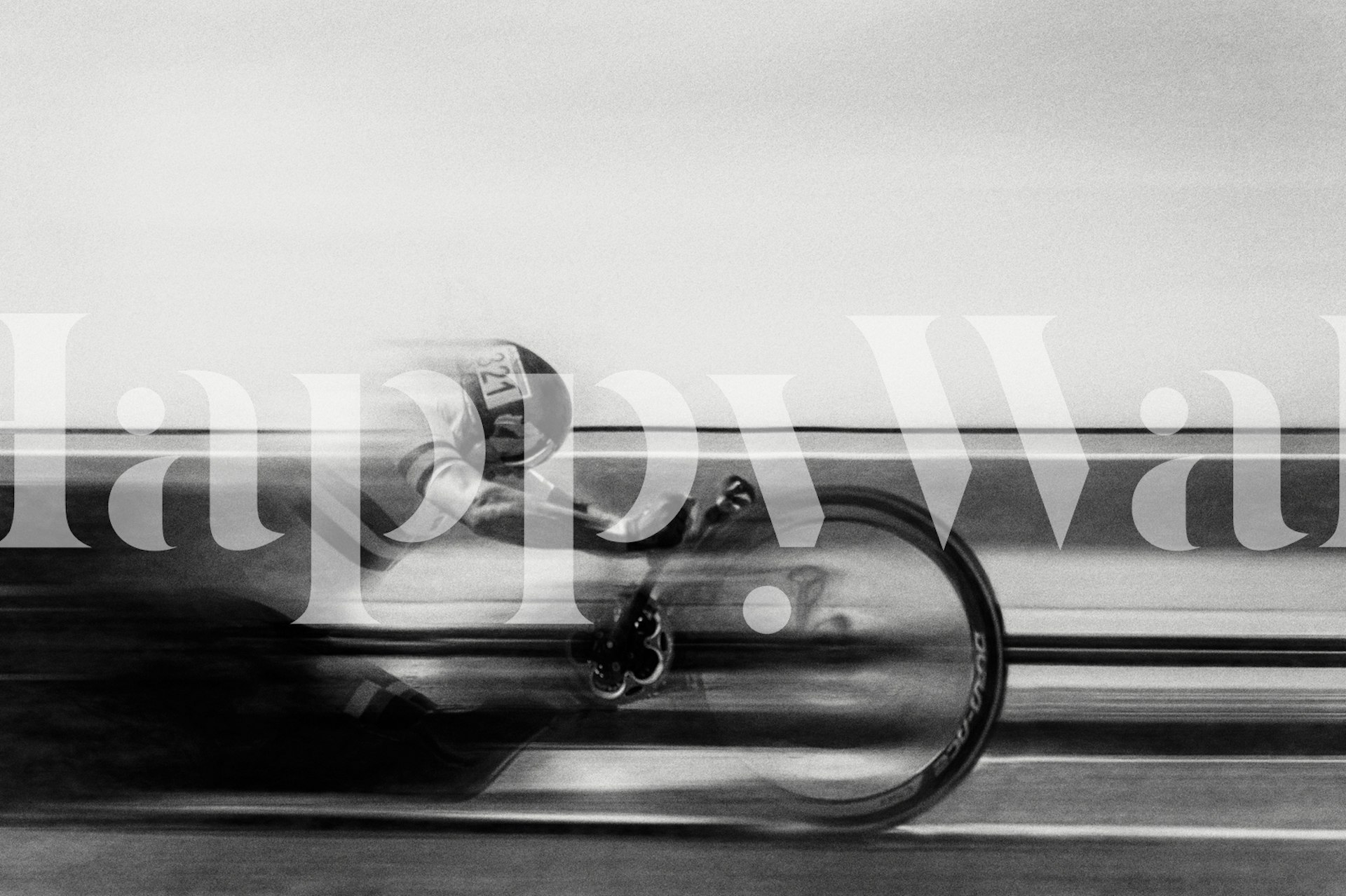 A cyclist in motion, captured in black and white wallpaper.