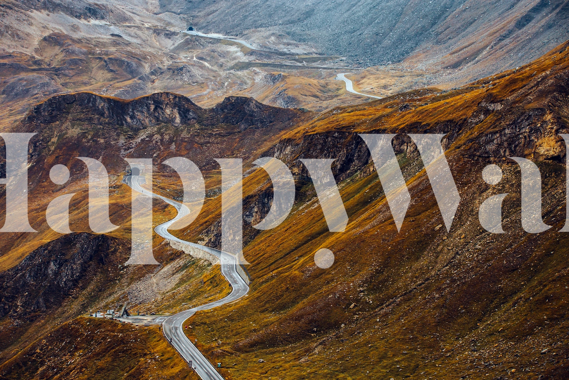 Curvy mountain road on hills in earthy colors wallpaper