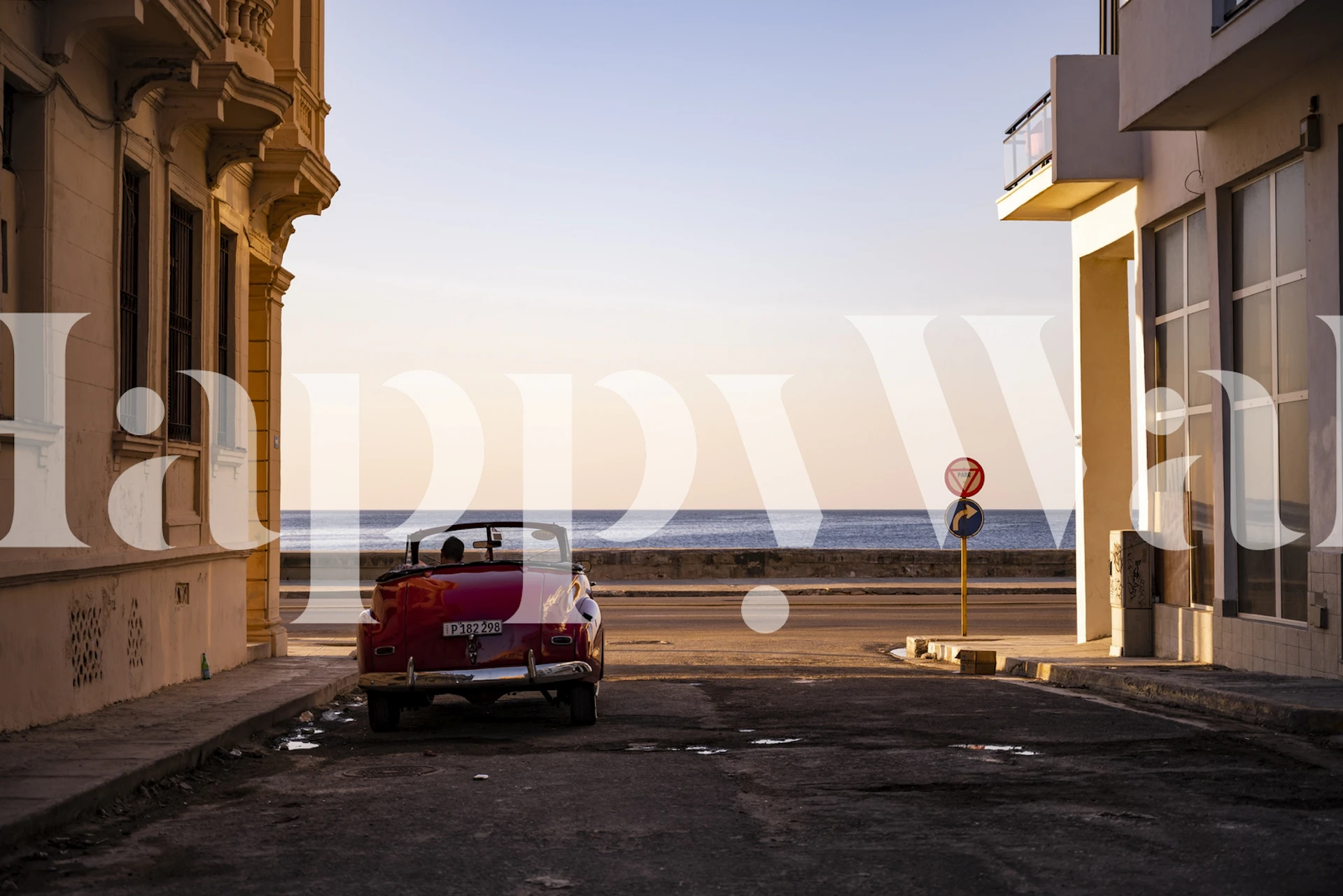 Vintage red car on a Havana street at sunset wallpaper