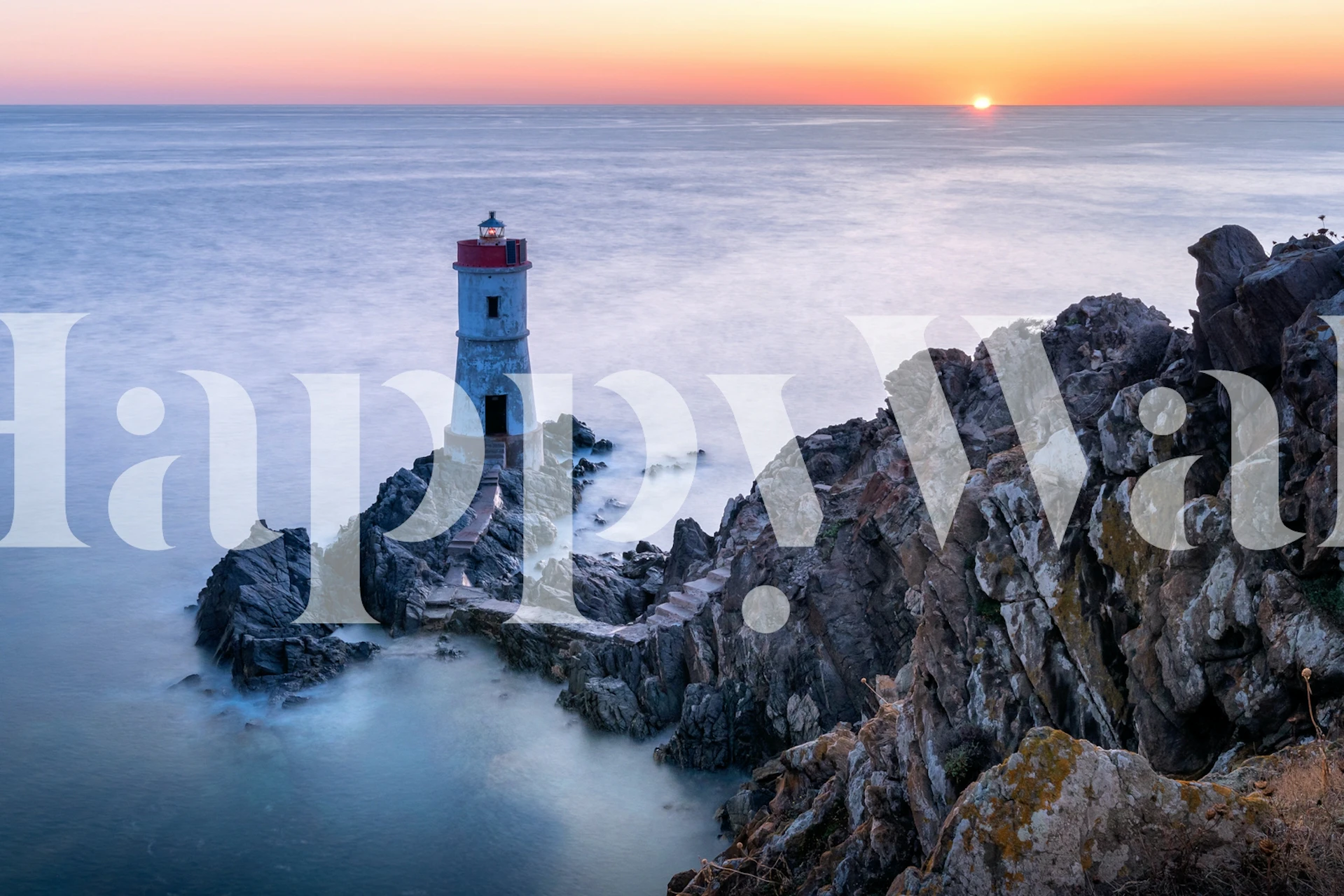 Coastal lighthouse on rocky shore at sunset wallpaper