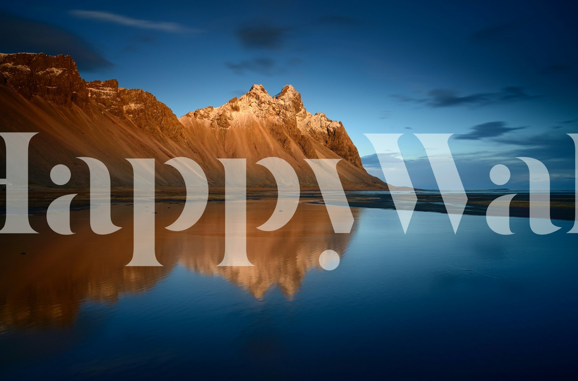 Mountain landscape reflecting in water at sunset wallpaper
