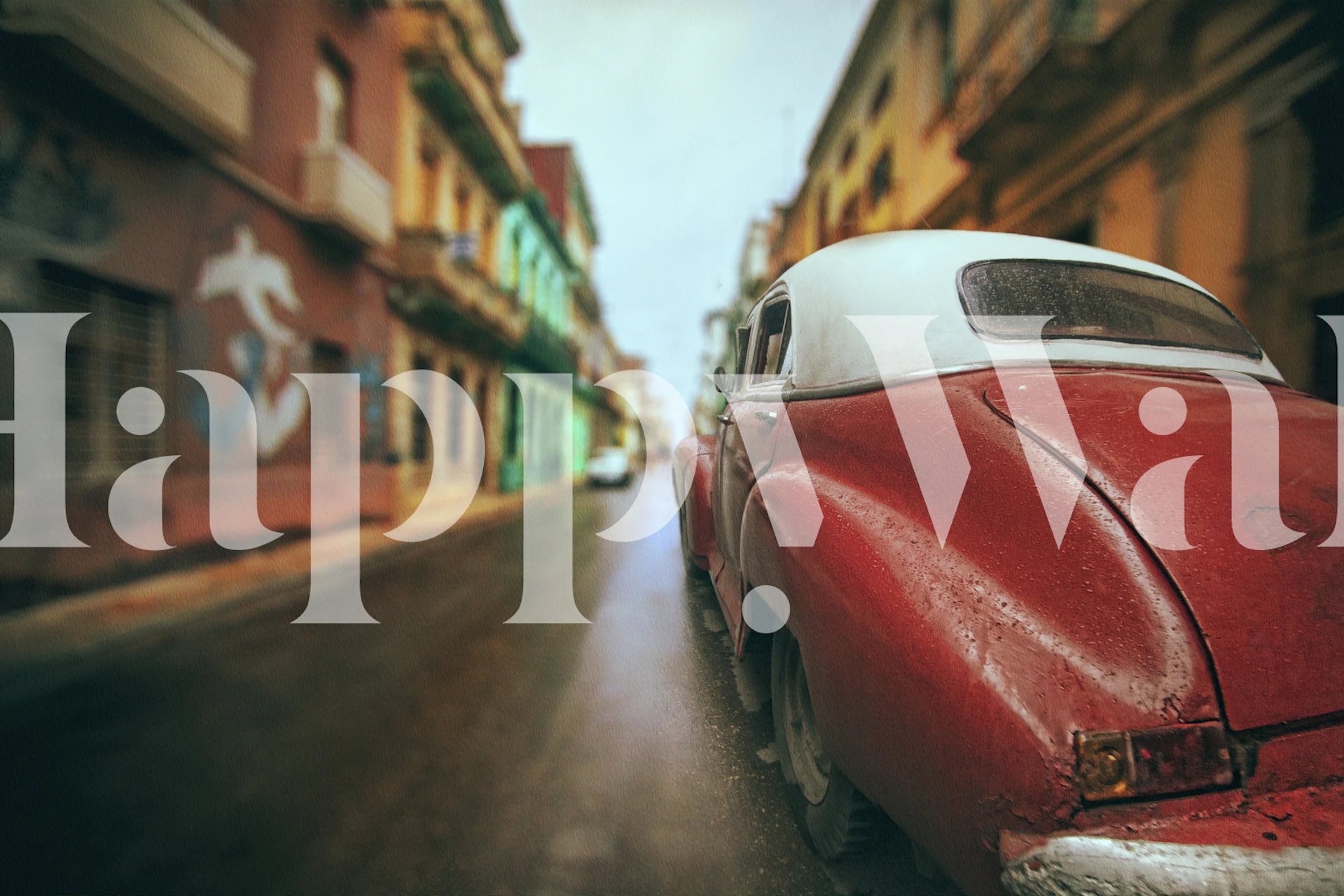 Cuban vintage car with backdrop of colorful street buildings wallpaper