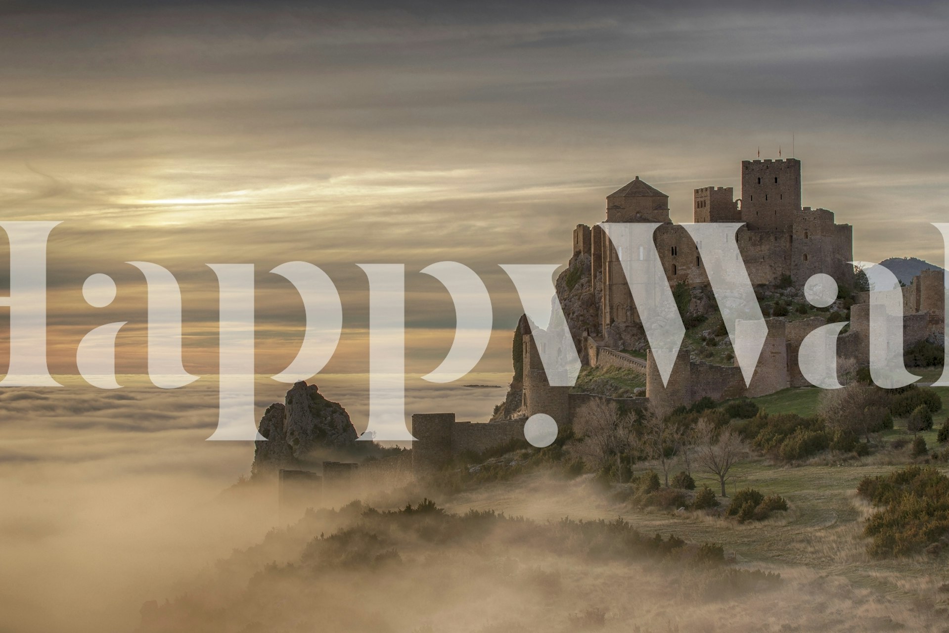 Medieval castle on a hill with sunset fog wallpaper