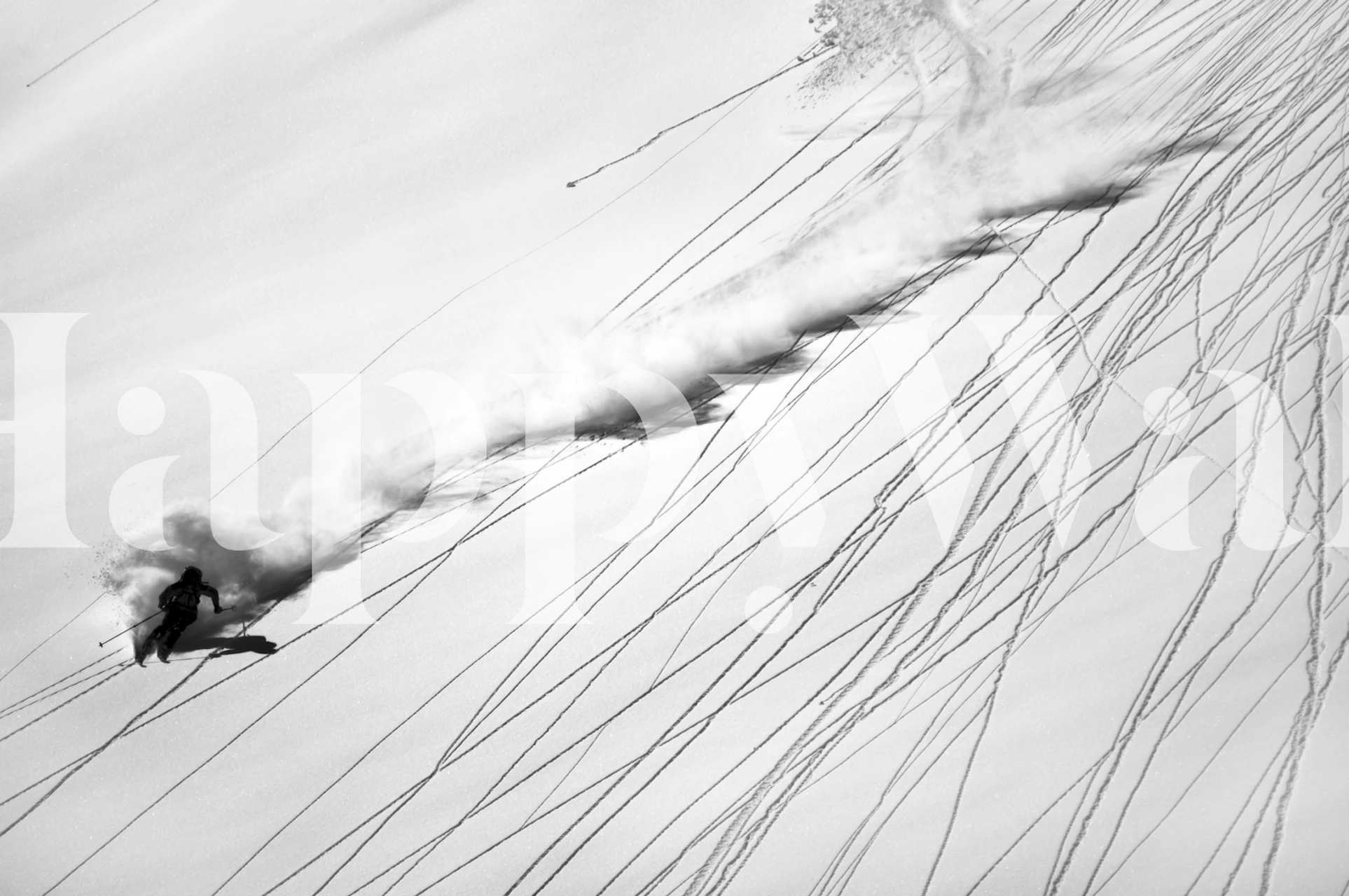 Snowboarder cutting through snow in black and white wallpaper