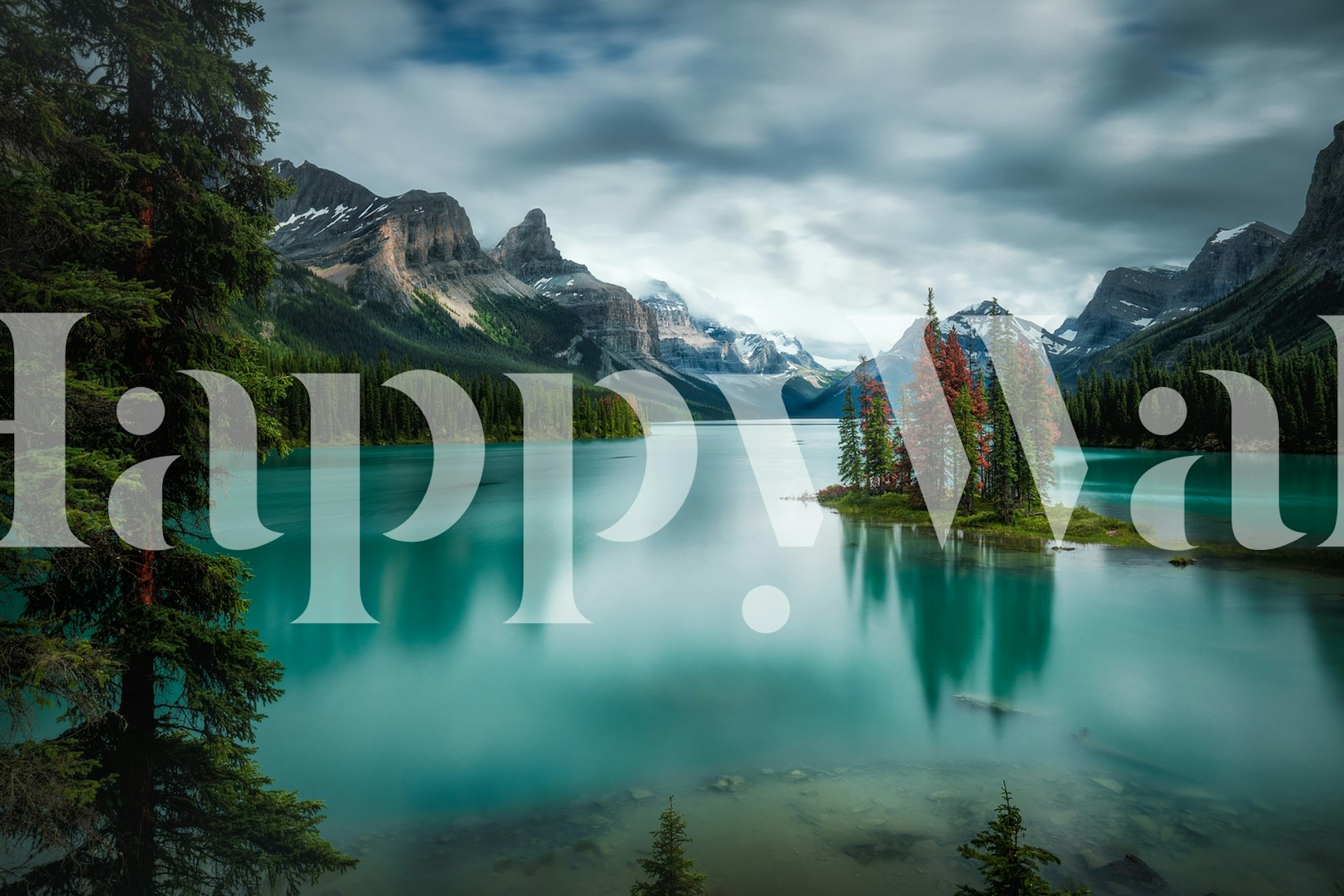 Mountain lake with lush green trees and rocky mountains wallpaper