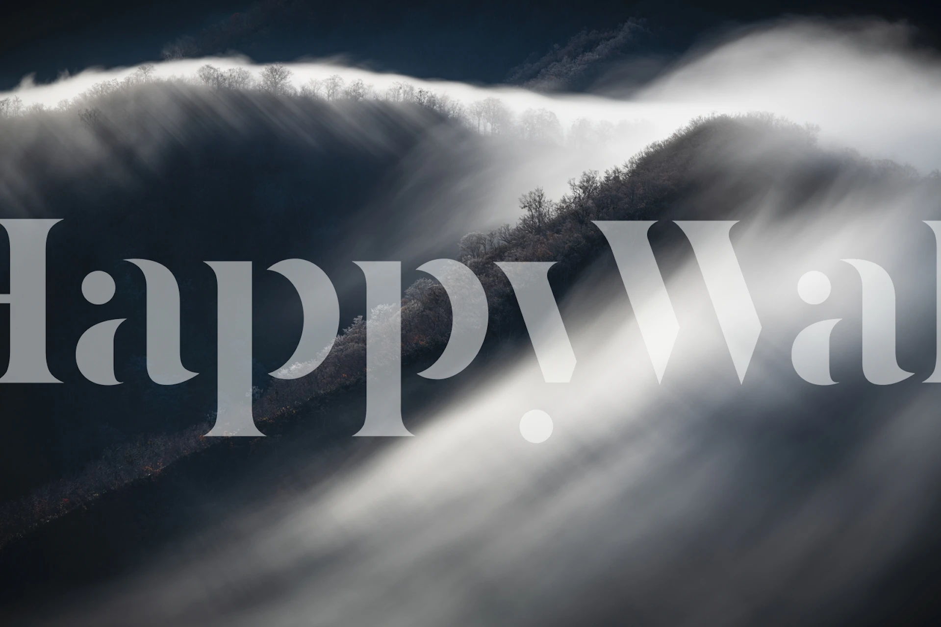 Foggy mountain landscape with soft clouds and dark hills wallpaper