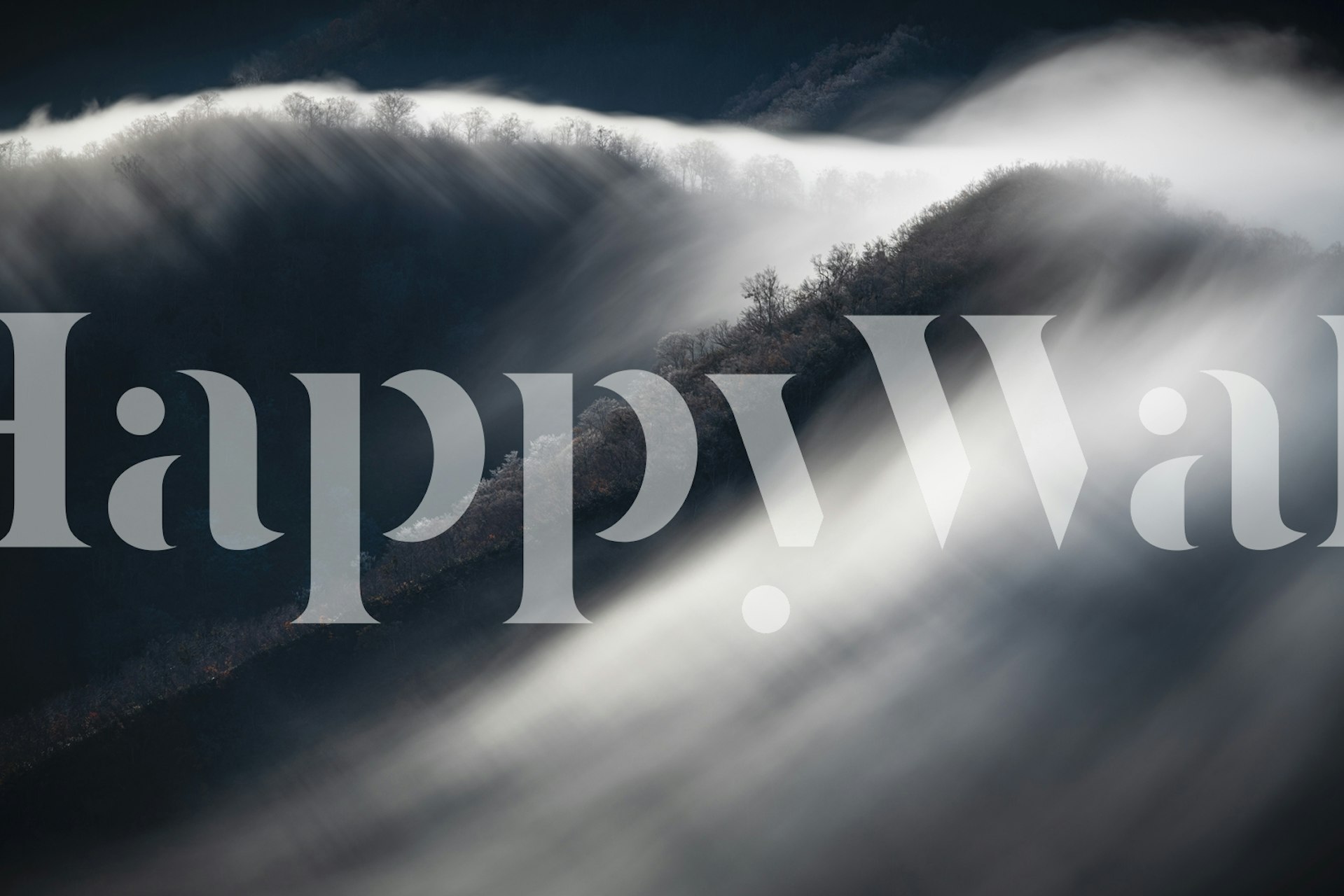 Foggy mountain landscape with soft clouds and dark hills wallpaper