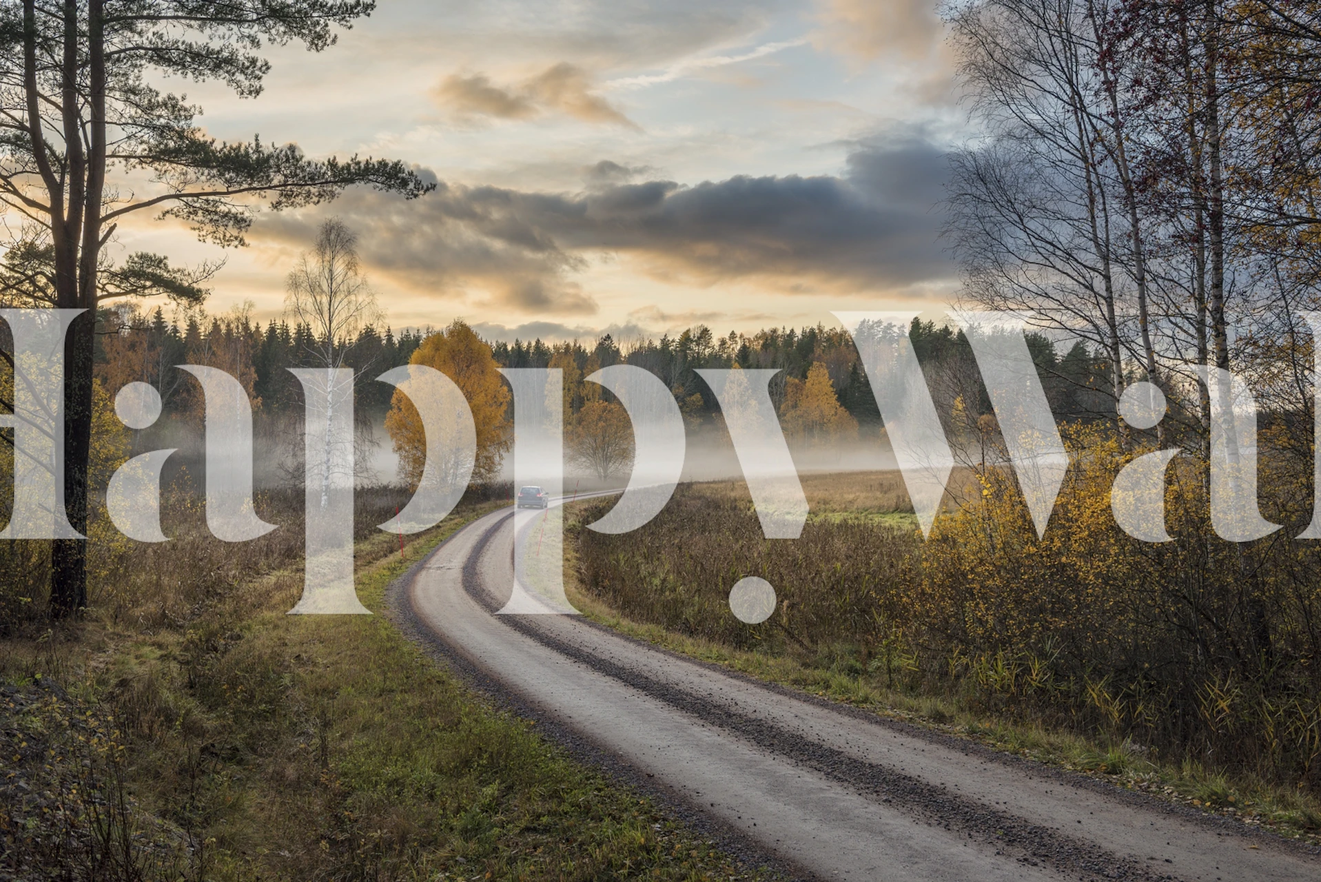 Autumn landscape wallpaper with winding road, yellow trees, and clouds