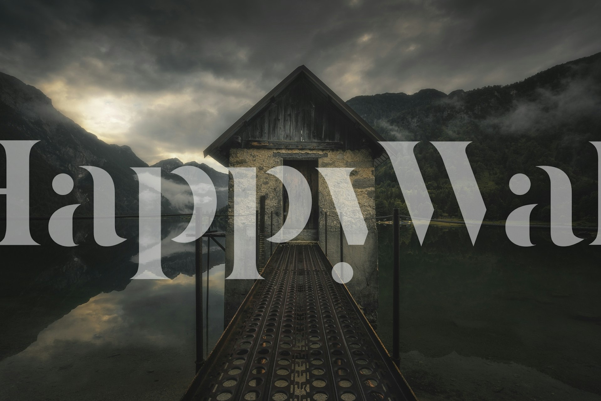 A serene lake view with a rustic house and mountains wallpaper