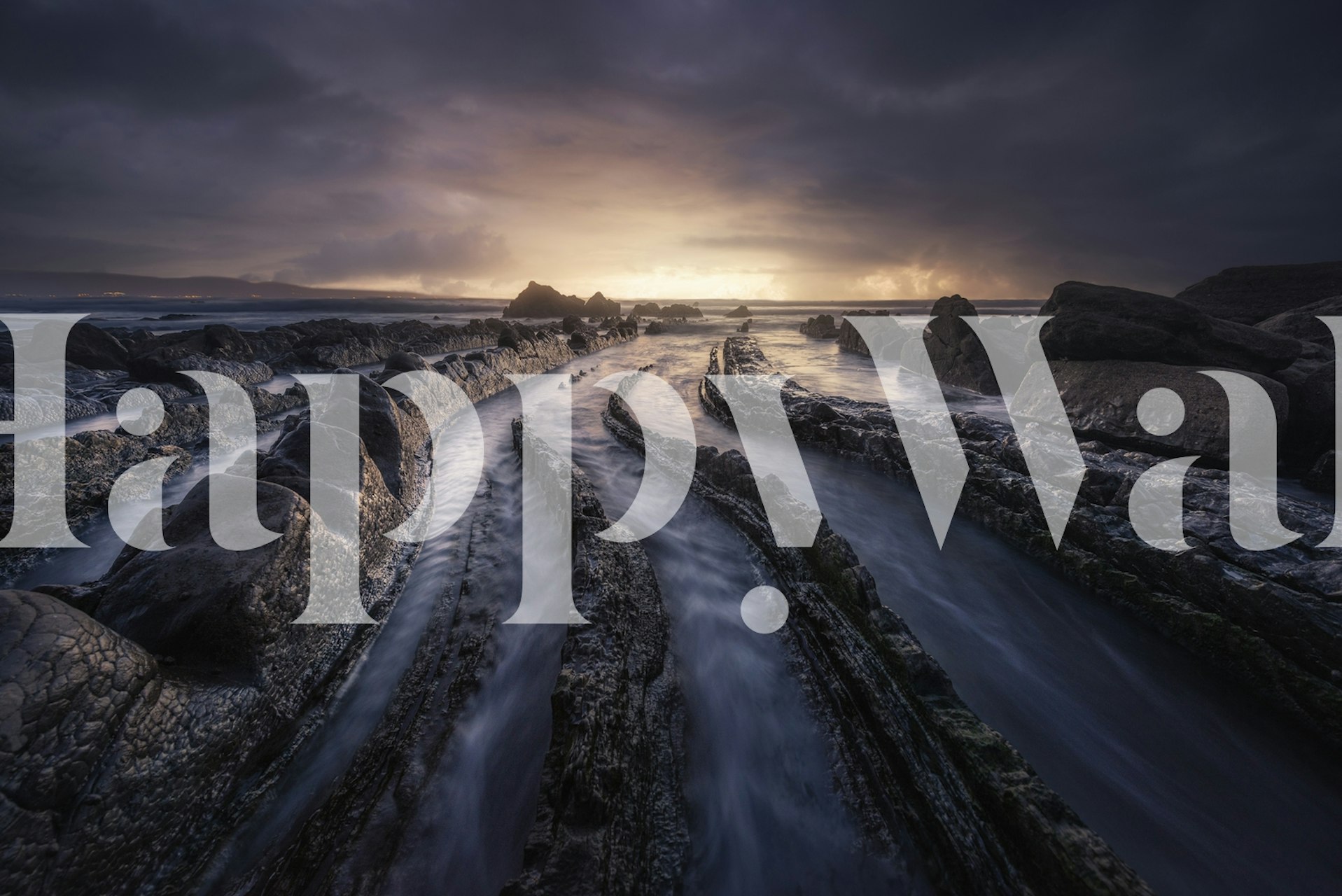 Coastal landscape wallpaper with textured rocks and water