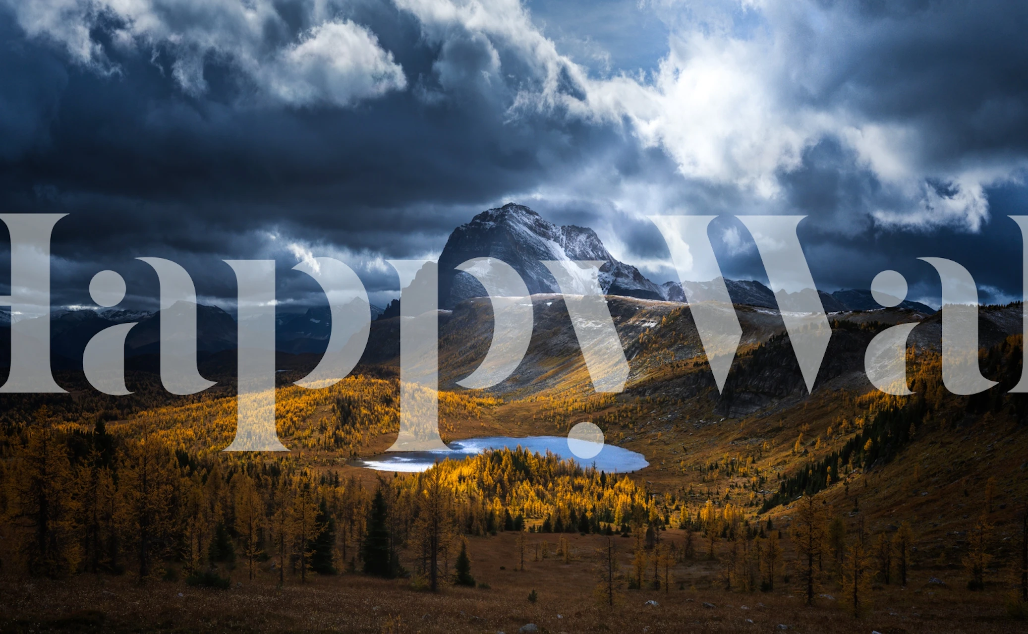 Majestic mountain landscape with golden autumn trees, blue lake, and dramatic clouds wallpaper