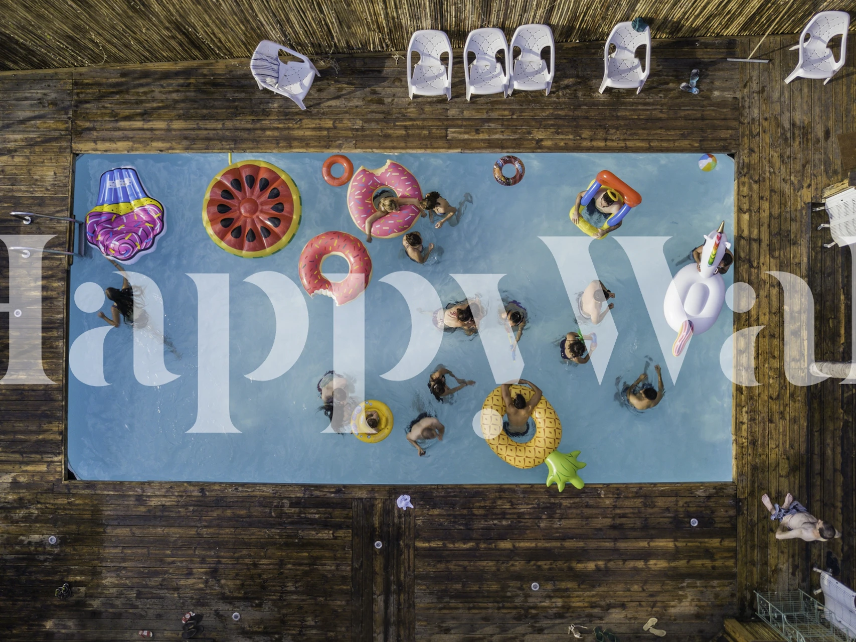 Colorful pool party scene with floating rings and people in water wallpaper