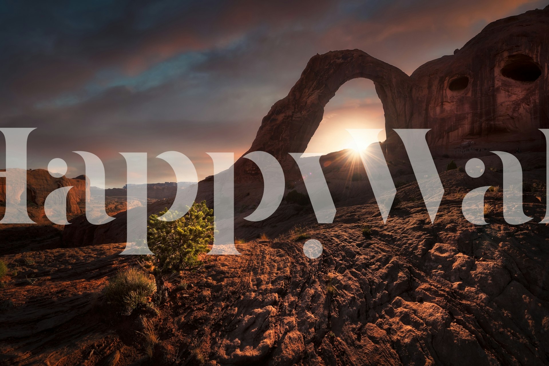 Rock formation arch at sunset with warm tones wallpaper