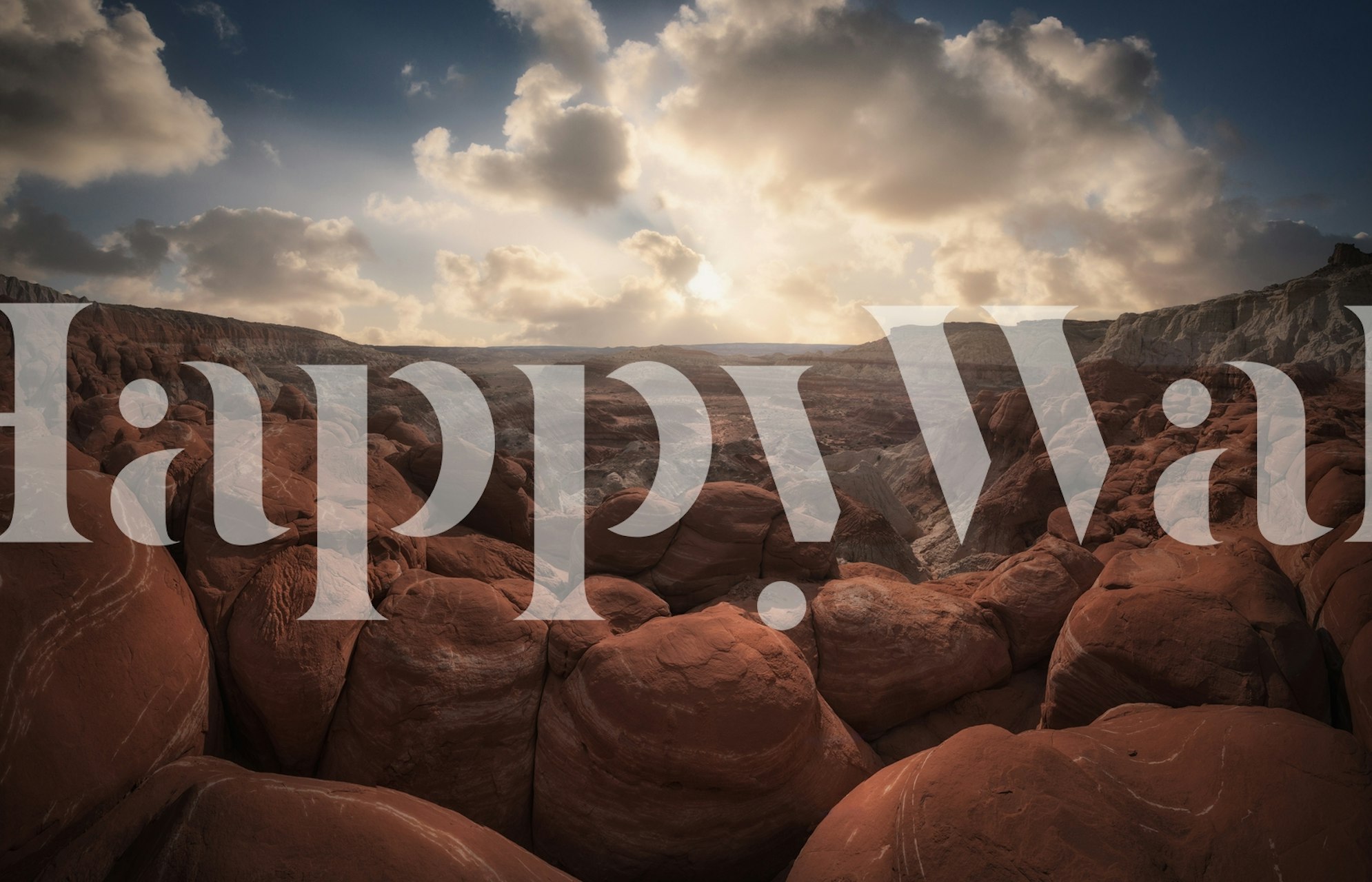 Red rocky landscape under cloudy sky wallpaper