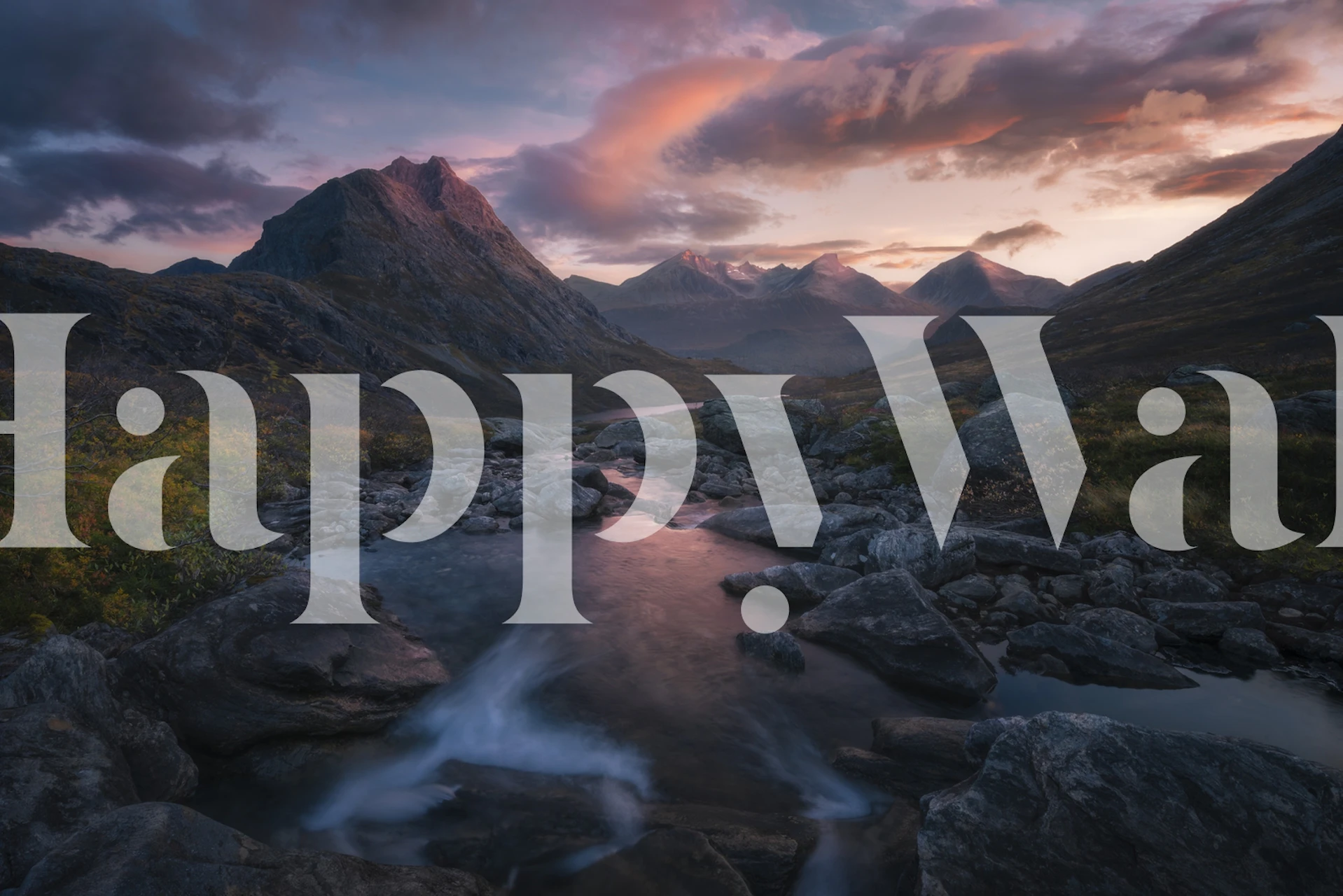 Mountain river flowing through rocky landscape under sunset sky wallpaper