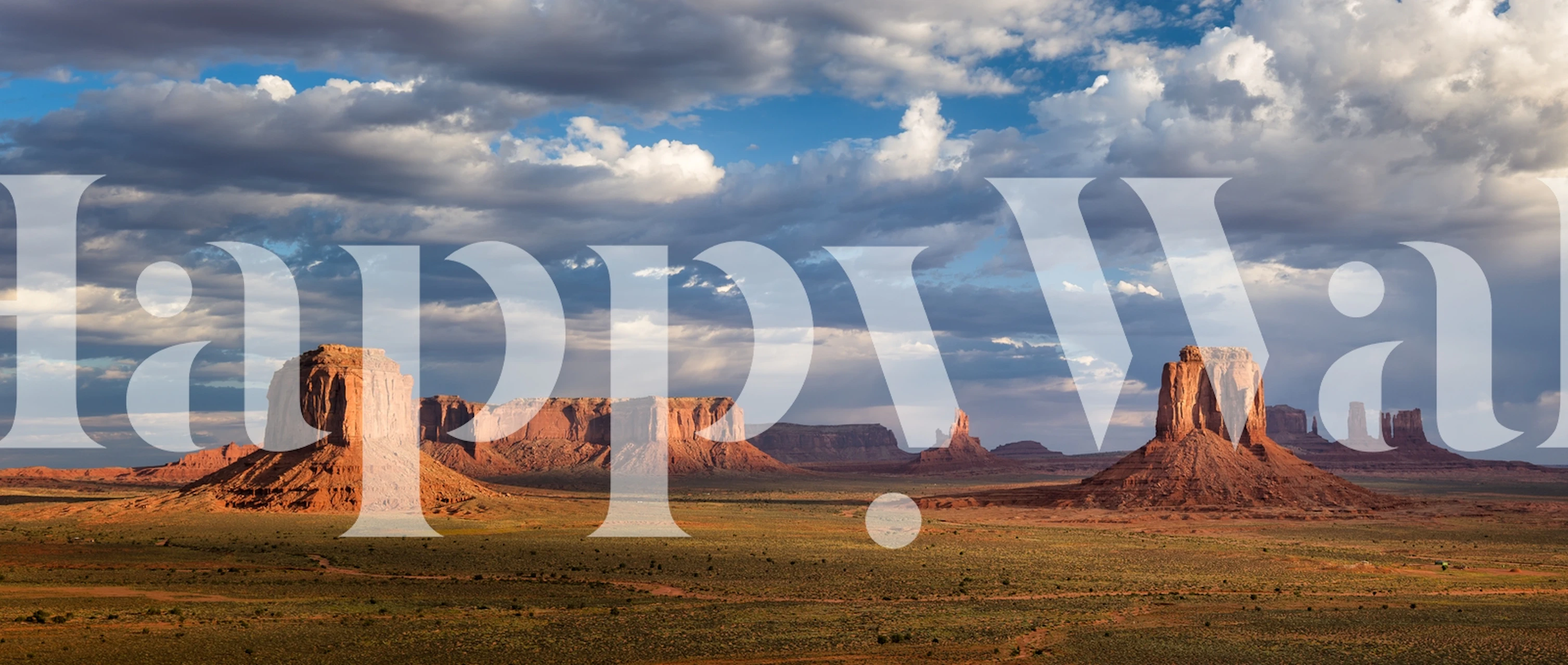 Desert rock formations under blue sky with clouds wallpaper