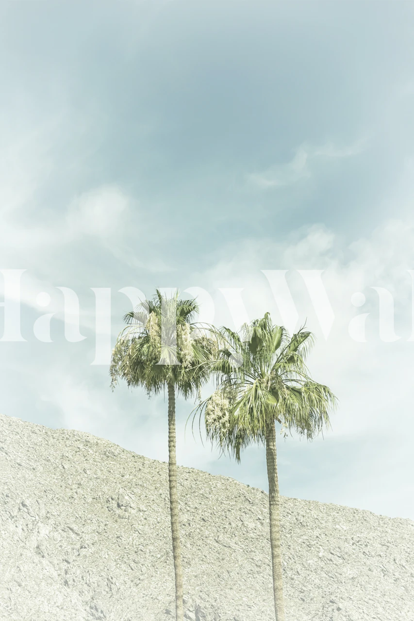 Two palm trees against a light blue sky wallpaper
