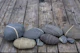 Striped Pebble On Old Wood