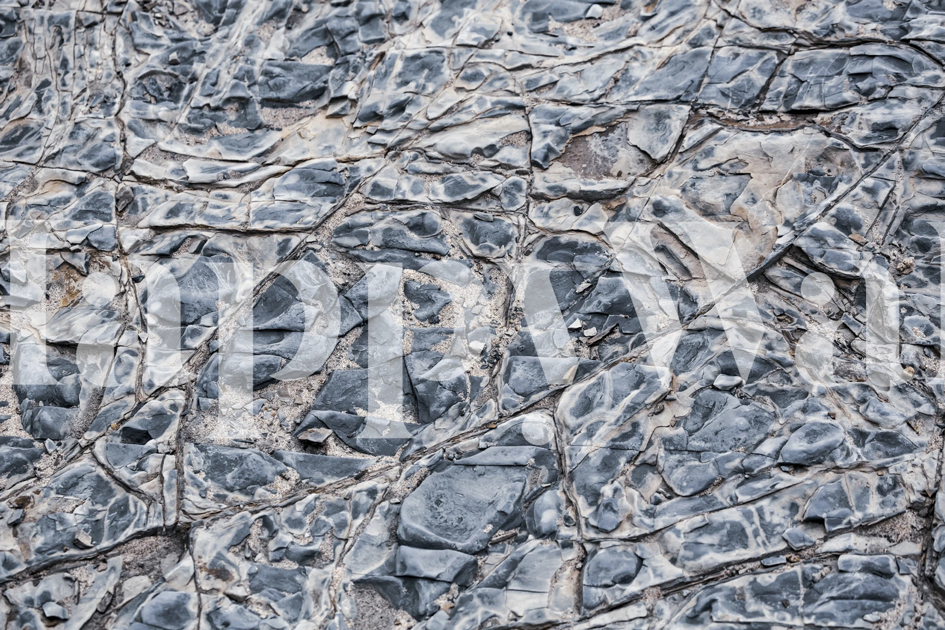 Textured grey rock wallpaper featuring layered stone patterns