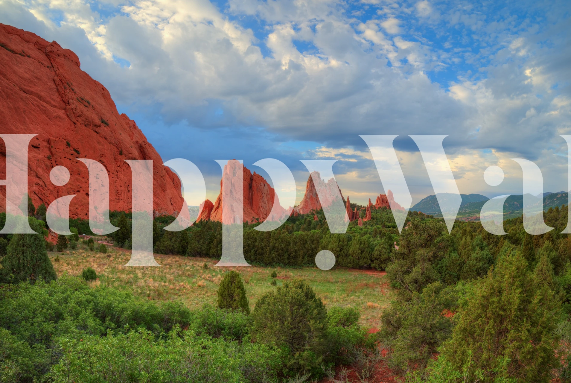 Mountain view with red rock formations and lush greenery wallpaper