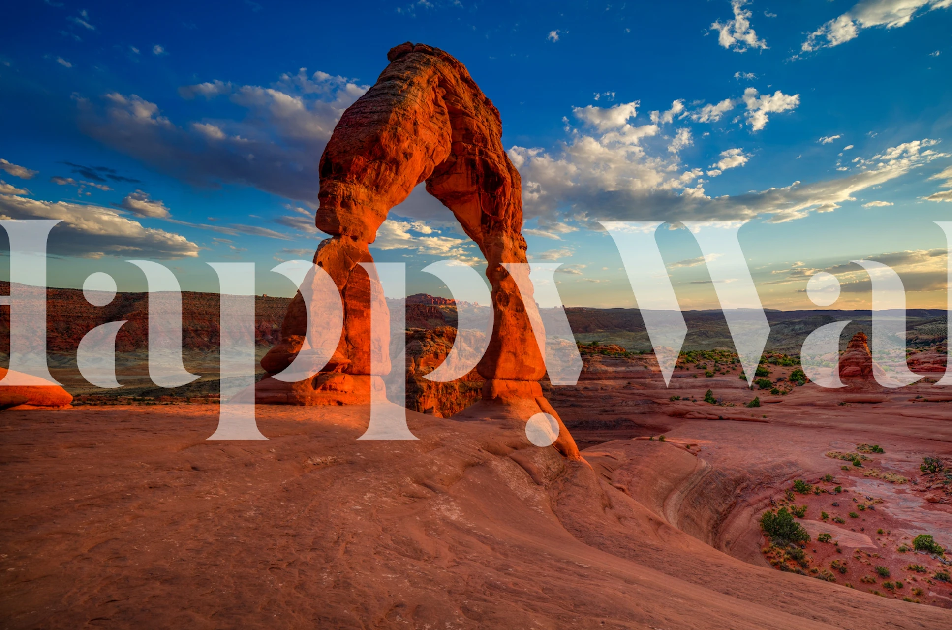 Red rock formations under blue sky with clouds wallpaper
