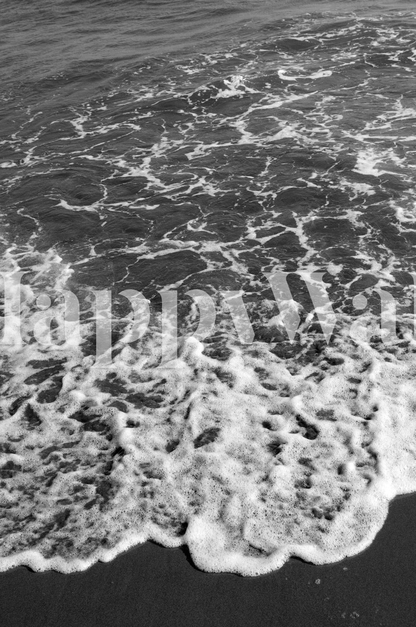 Seafoam green waves with white surf foaming on the shore wallpaper