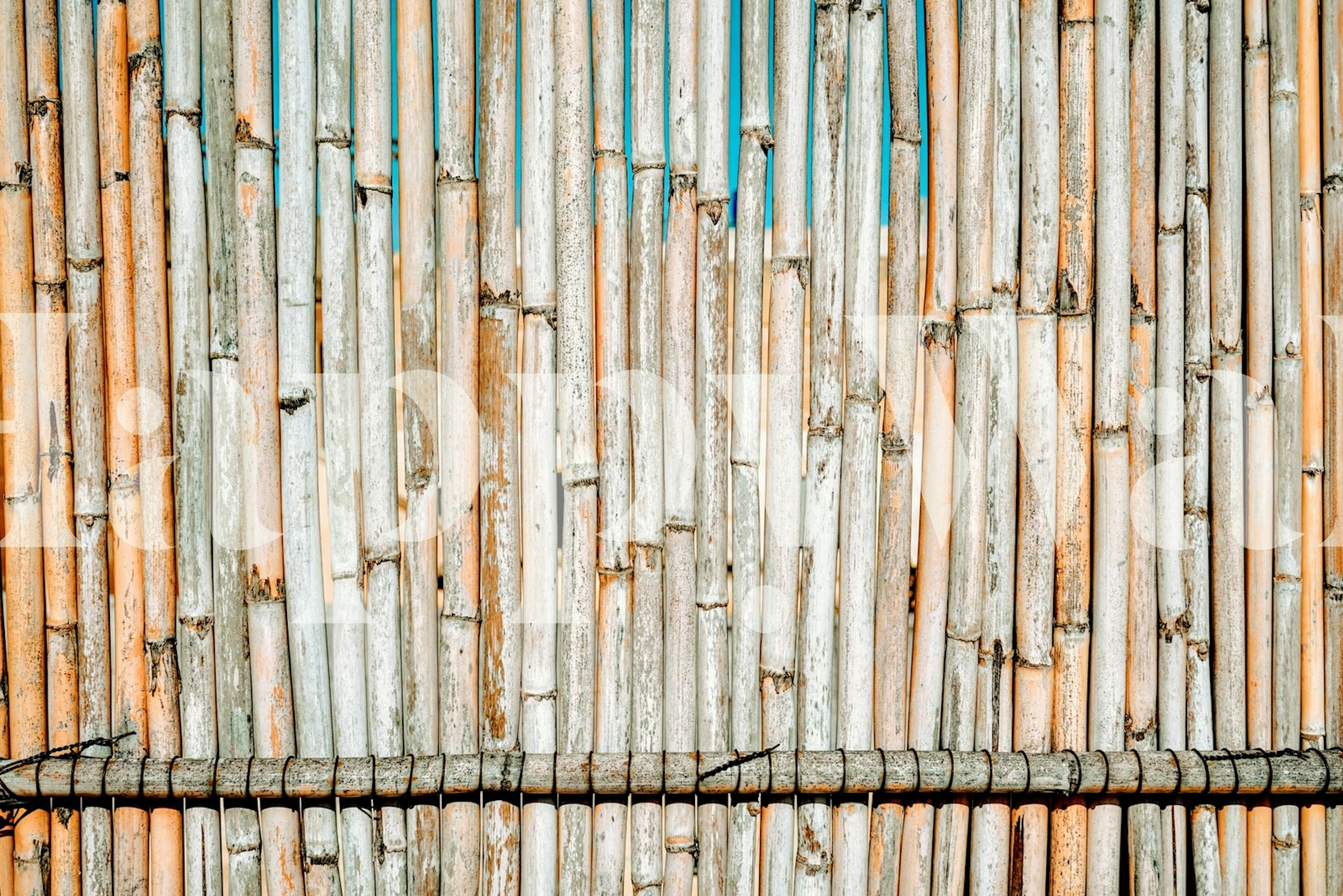 Worn bamboo wall mural with weathered and natural hues