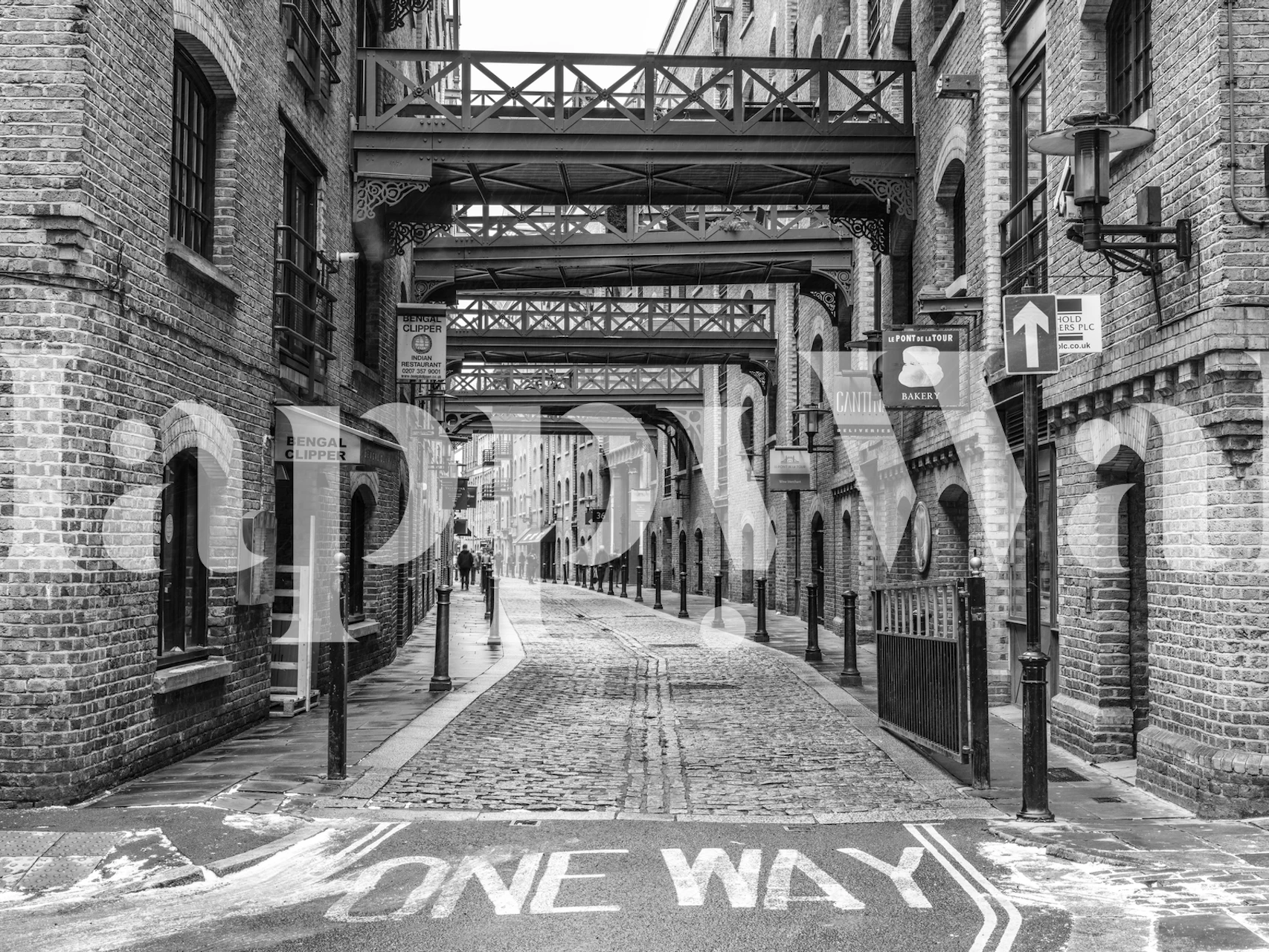 Historic London street with cobblestones and brick buildings black and white wallpaper